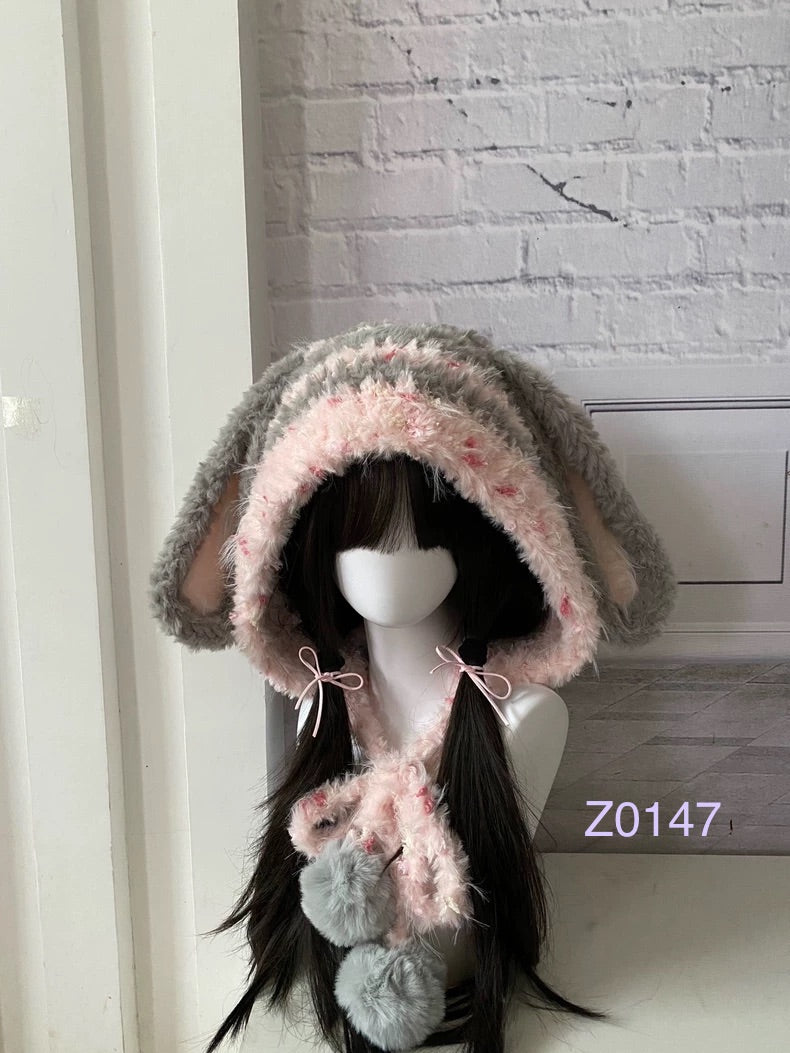 handmade crochet fairycore coquette bunny ear hood in gray and pink floral fluffy texture with long floppy ears, pink satin ribbons and plush pompom ties. Kawaii winter headwear for cosplay, photoshoot prop and romantic gift giving