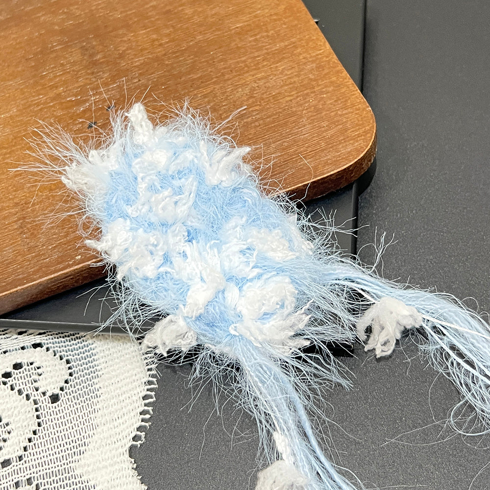 Side view pale blue cream blended yarn, lightweight cloud soft vegan fiber for handmade crafts