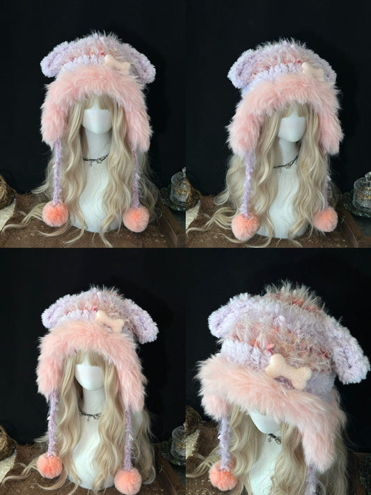 handmade crochet dog ear hat in pastel pink and purple shaggy faux fur with a crochet bone charm, long braided ties and soft pompom ends, a kawaii winter accessory