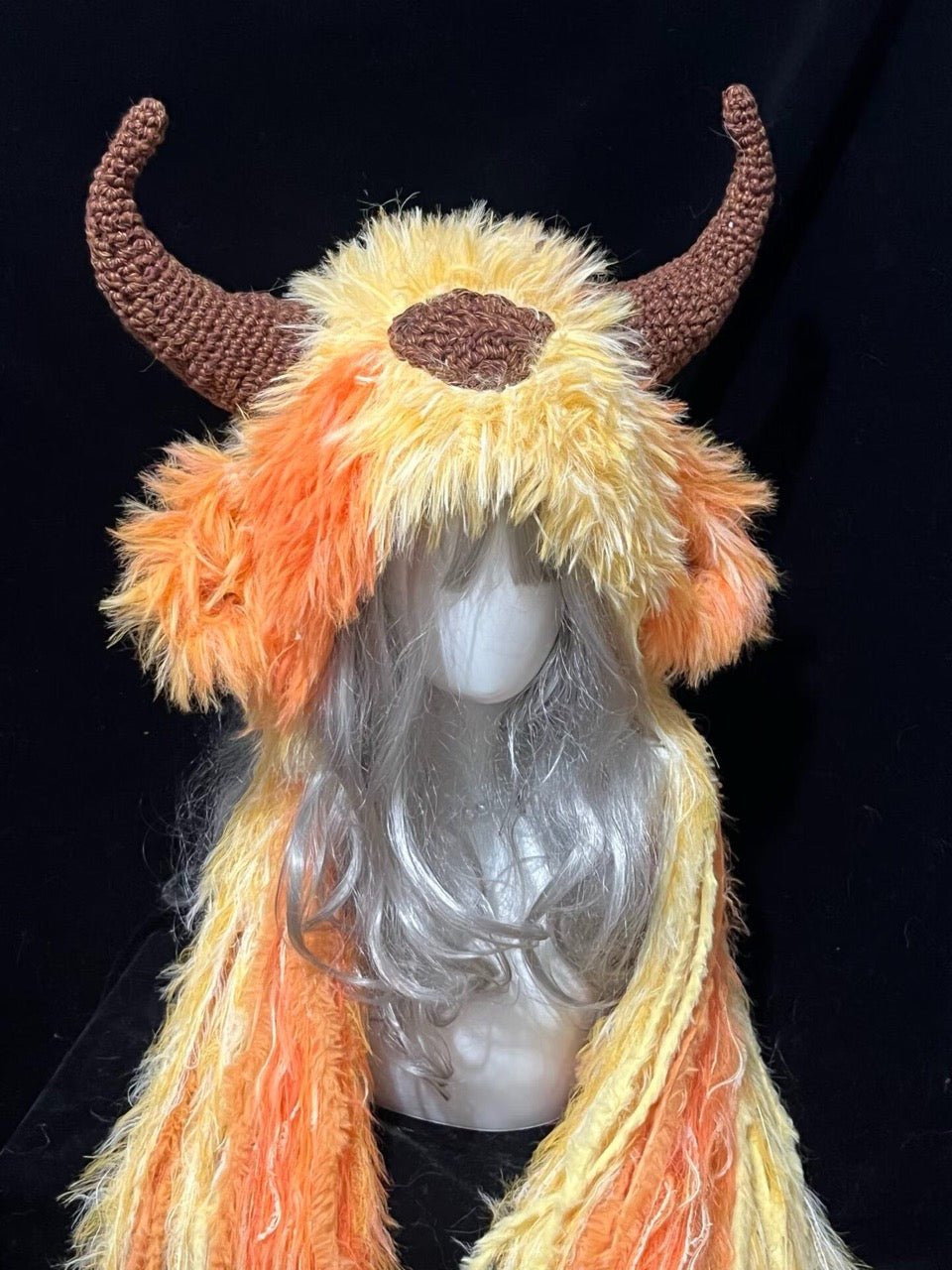 handmade crochet goblincore goat horn hood in orange and yellow gradient shaggy texture with brown curved horns, festival and cosplay accessory