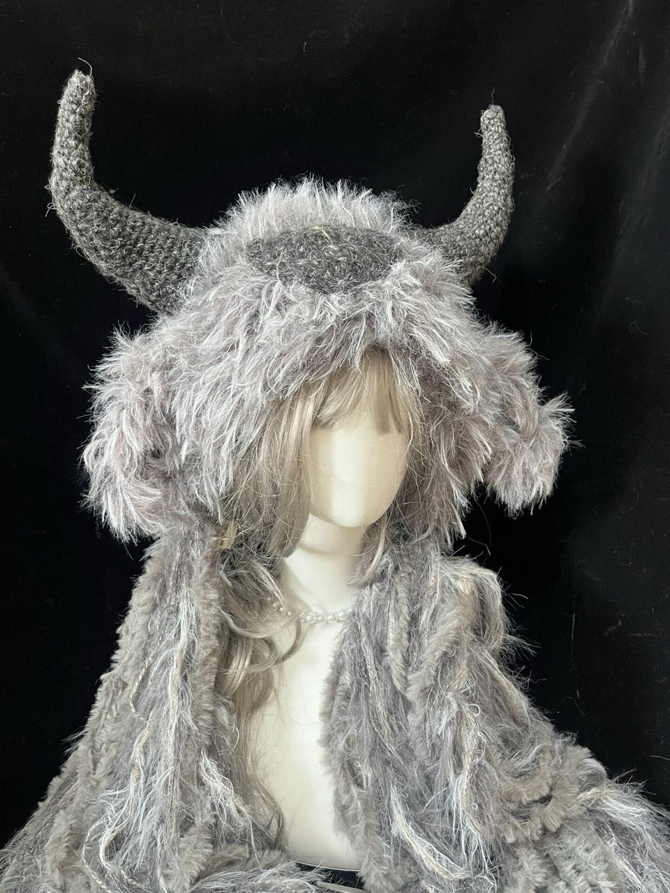 handmade crochet dark fairycore goat horn hood in gray and white shaggy texture with curved gray horns, fantasy festival headwear