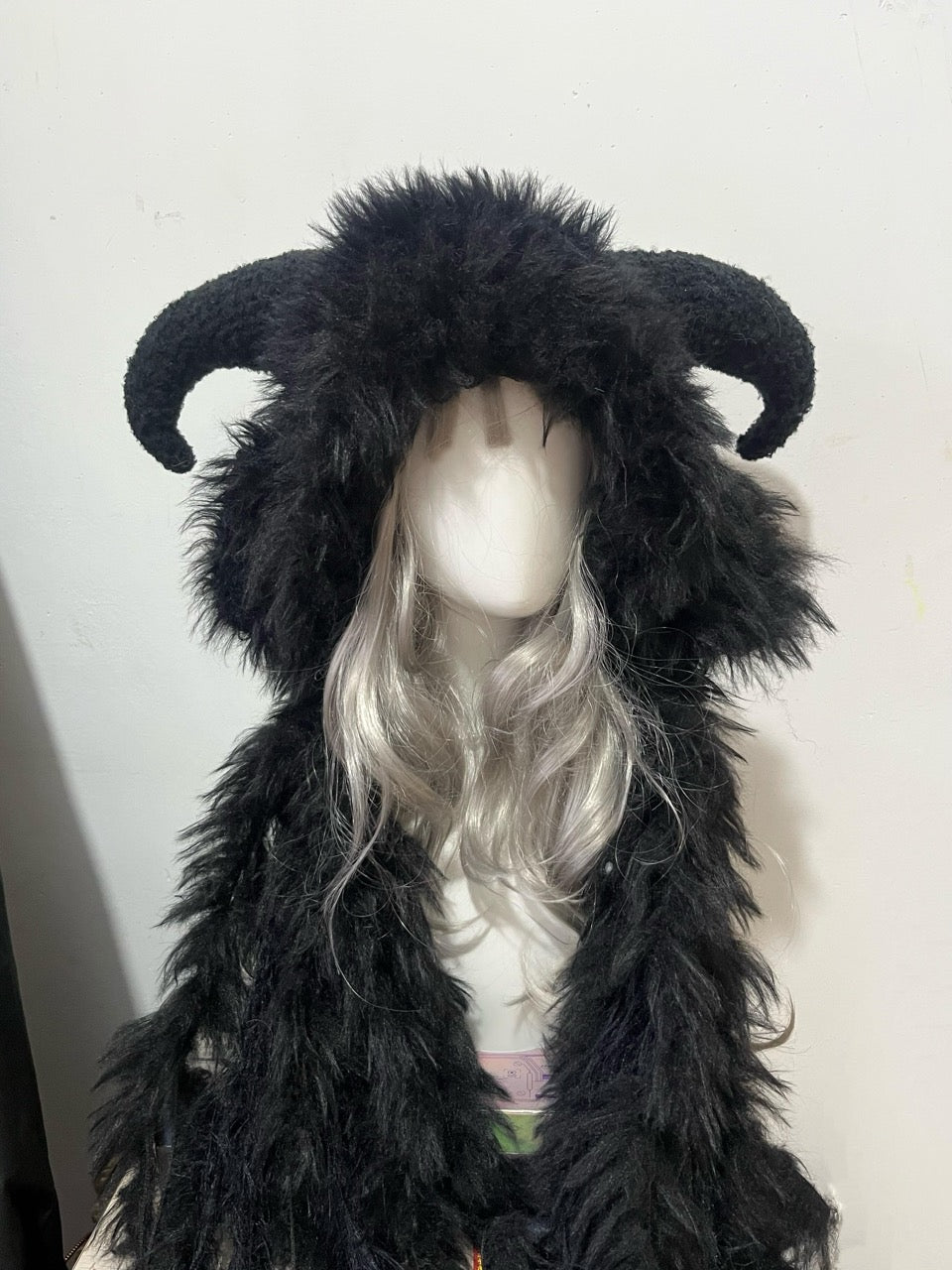 handmade crochet gothic goat horn hood in deep black shaggy texture with curved black horns, dark fantasy cosplay and rave accessory