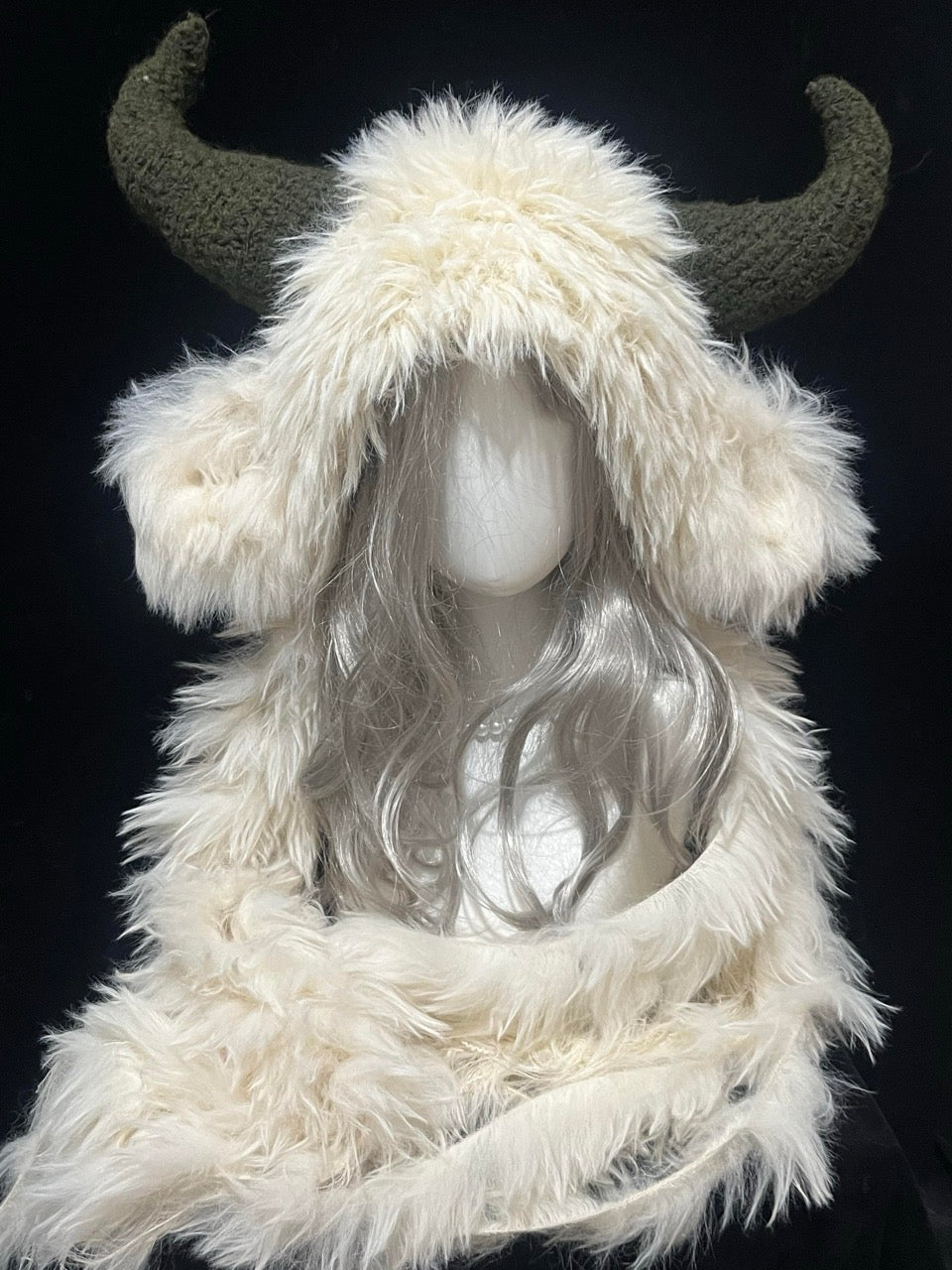 handmade crochet goblincore goat horn hood in cream shaggy texture with dark green curved horns, woodland cosplay hat