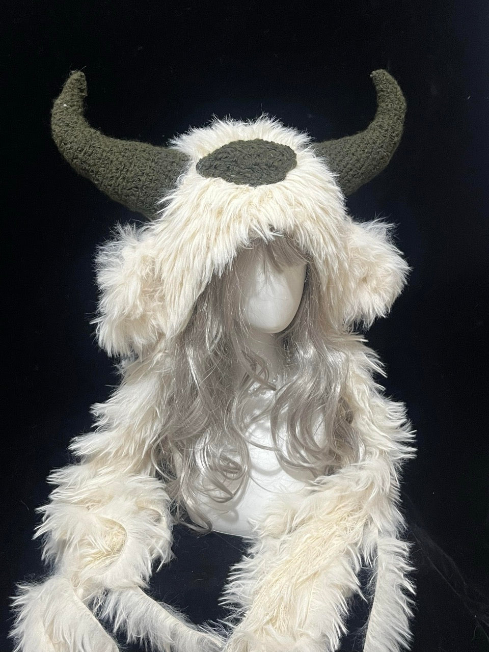 handmade crochet goblincore goat horn hood in cream shaggy texture with dark green horns and forehead patch, fantasy festival accessory