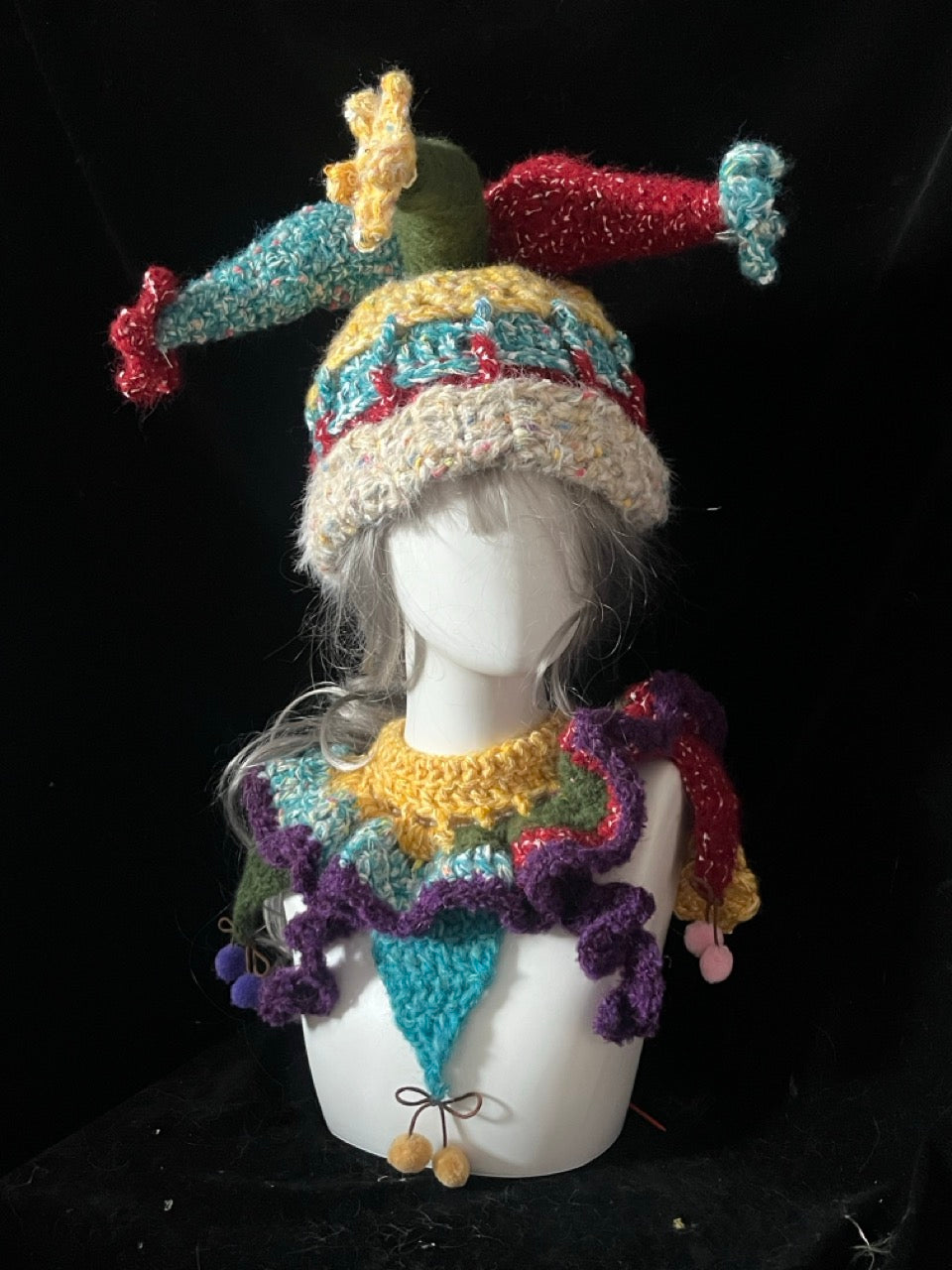 handmade crochet clowncore jester hat in vintage multicolor yarn with long floppy points and matching ruffled collar, whimsical circus cosplay accessory