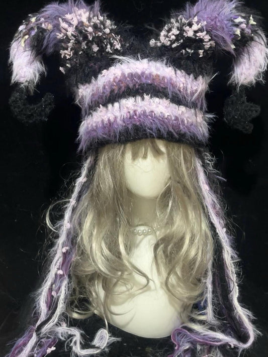 handmade crochet dark fairycore jester hat in black and purple floral shaggy texture with oversized curved points and long tassels, whimsical festival hat
