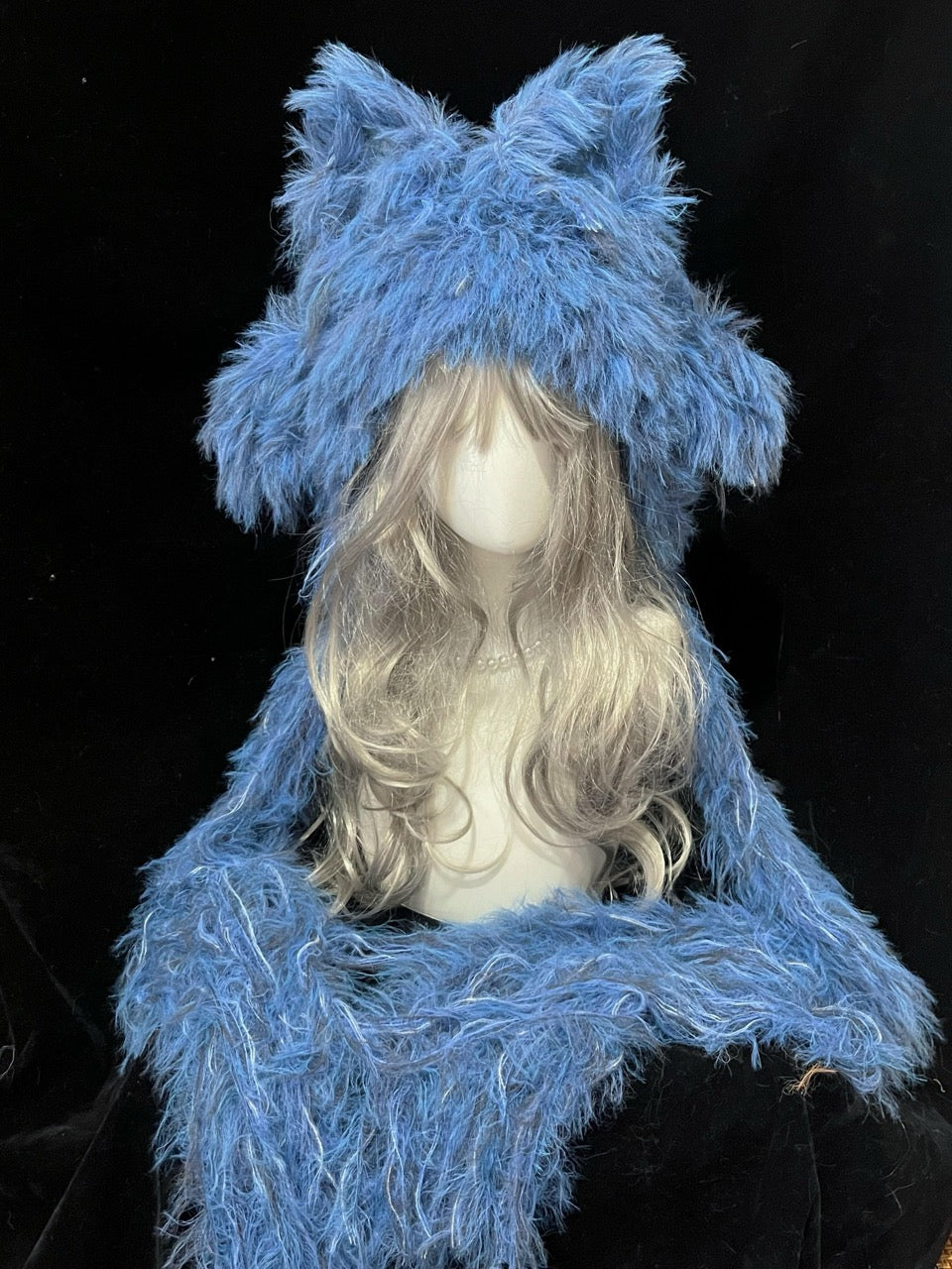 handmade crochet y2k fox ear hood in bright blue shaggy yarn, featuring tall pointed ears and long draped sides, a statement animal hat for raves and festivals