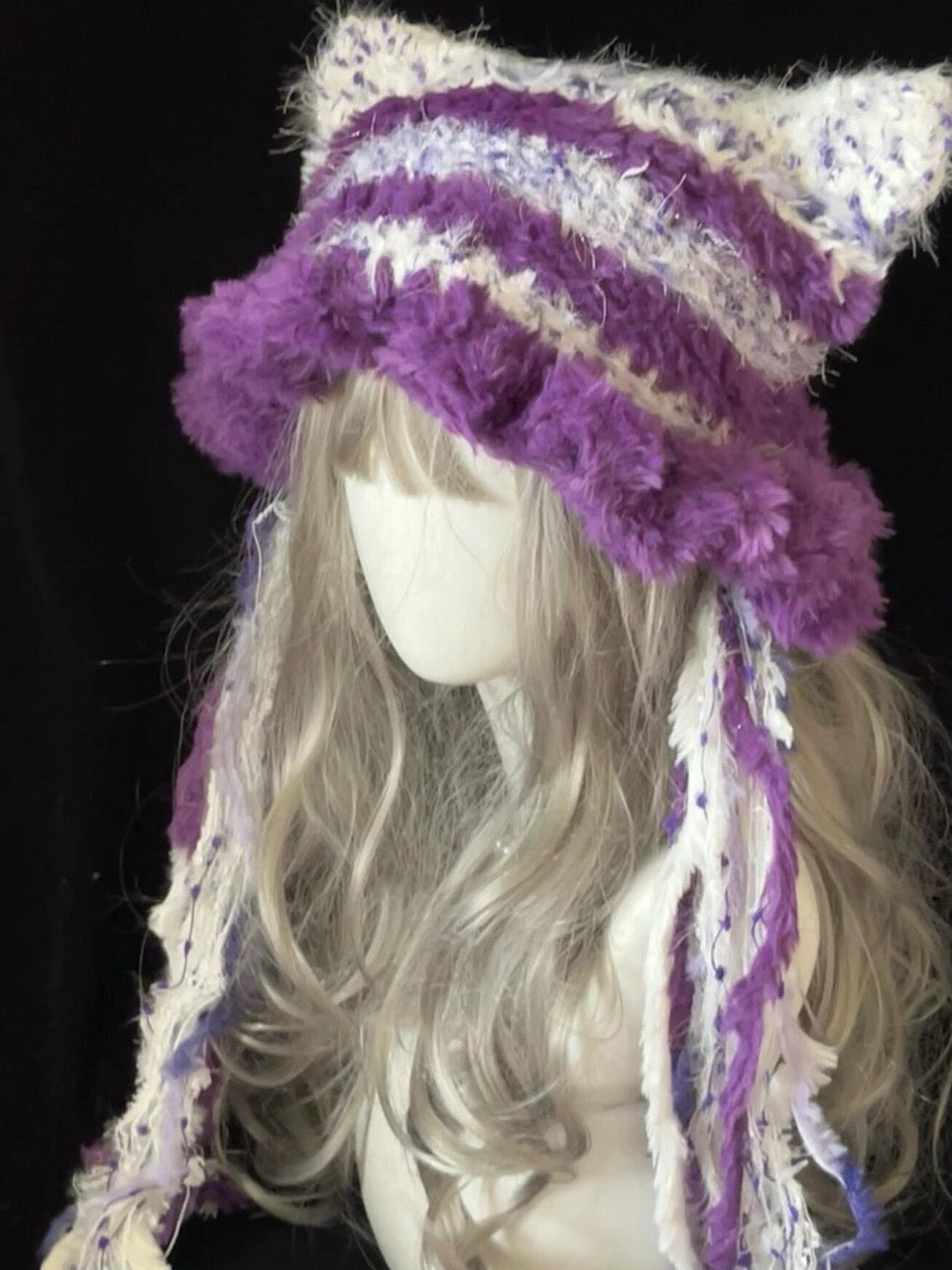 handmade crochet kawaii cat ear hat in purple and white striped shaggy texture, with tall pointed ears and long braided tassels, a cozy winter accessory for cosplay and daily wear