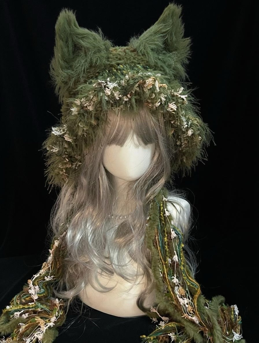 handmade crochet woodland fox ear hat in olive green floral shaggy texture, with pointed ears and long braided ties, a cottagecore forest cosplay hat