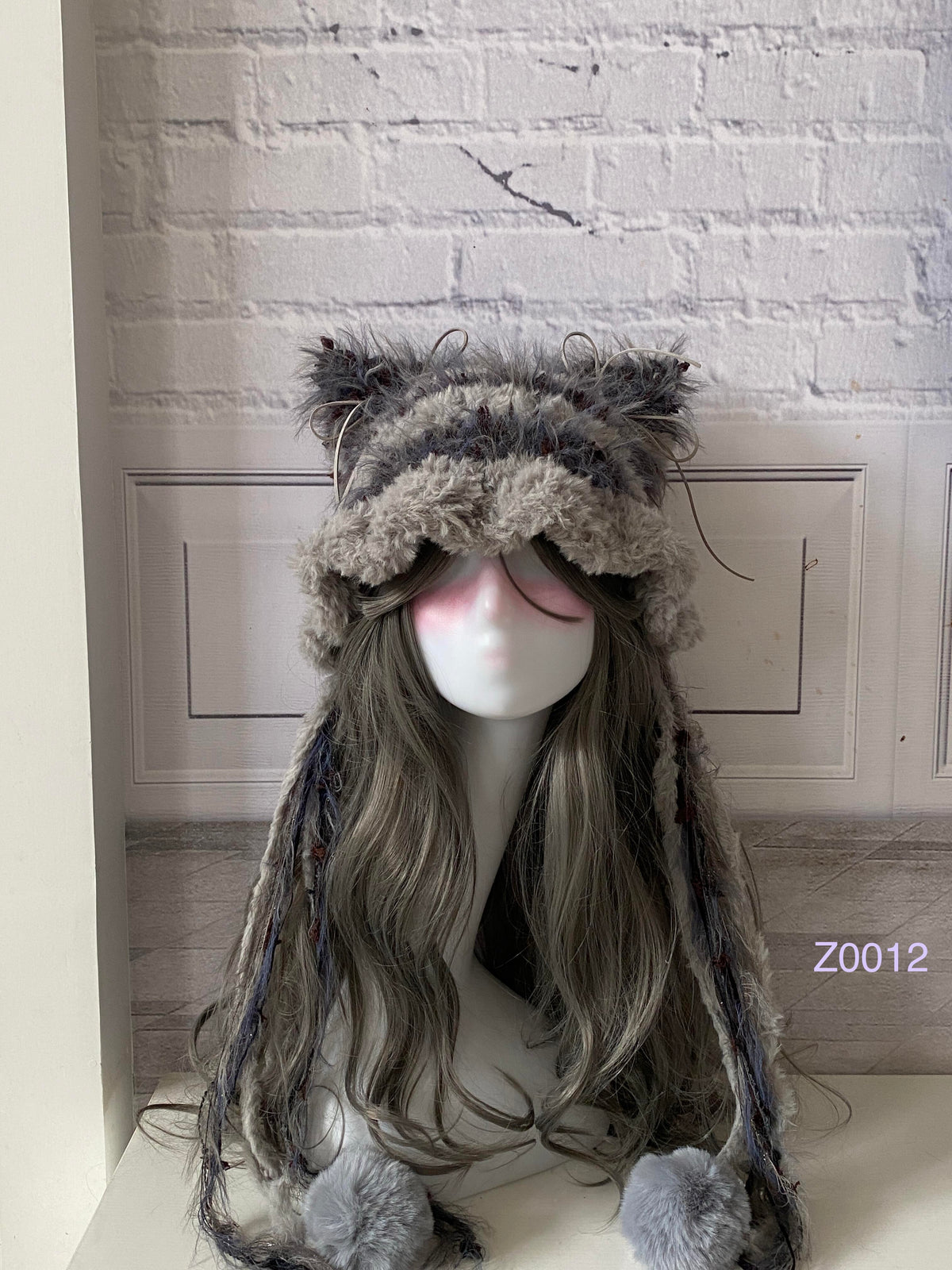 handmade crochet woodland goblincore cat ear hat in brown and gray mixed fluffy texture with pointed ears and plush pompom ties. Cottagecore headwear for cosplay, festival and photoshoot styling