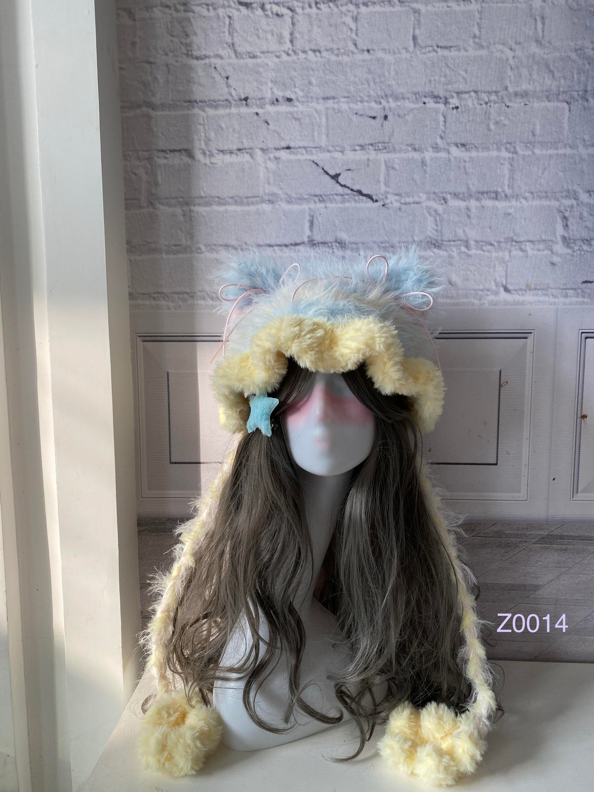 handmade crochet kawaii fairycore cat ear hat in pale yellow and blue fluffy contrast with pointed ears and soft pompom ties. Sweet winter headwear for cosplay, photoshoot prop and gift idea
