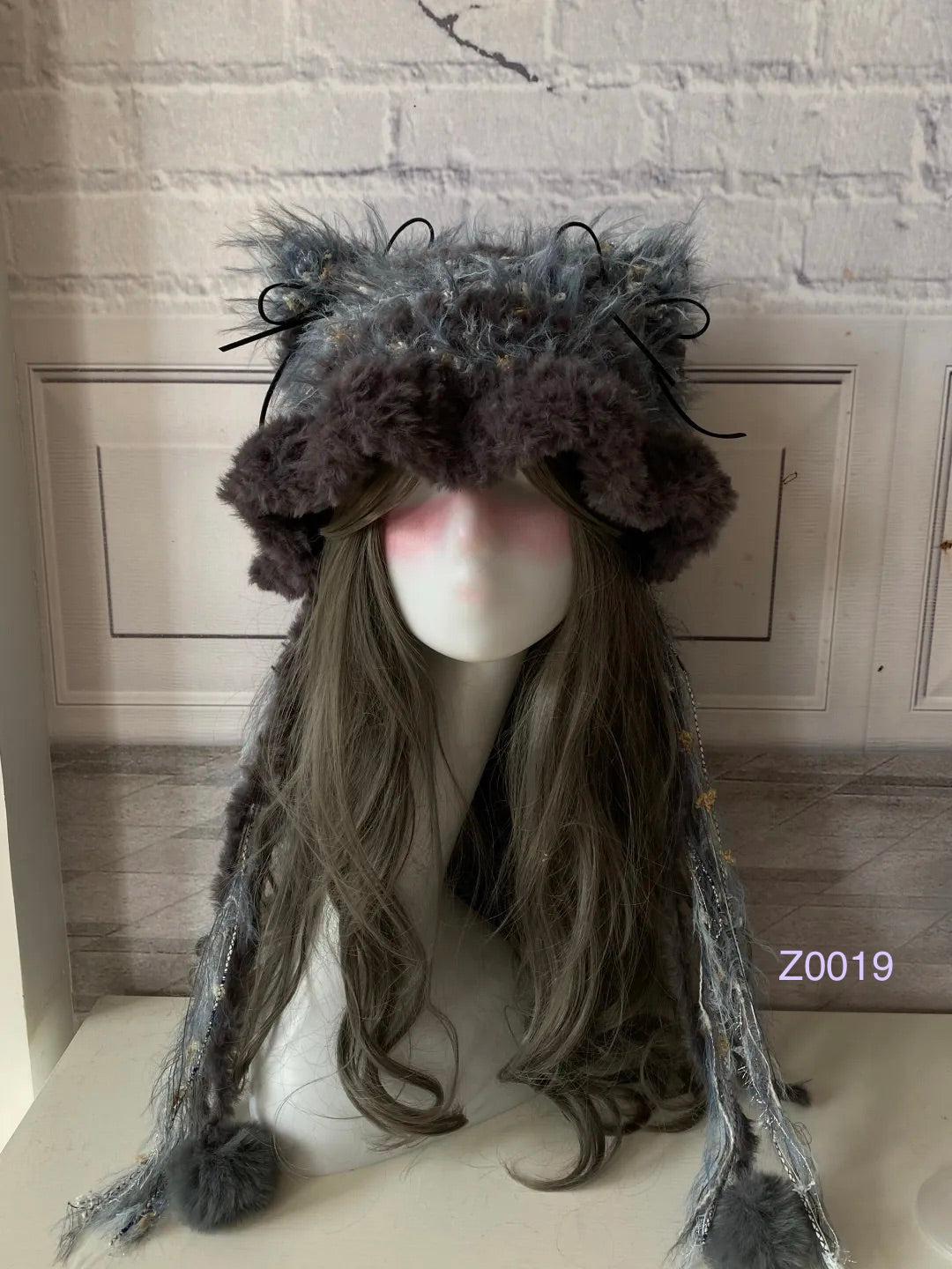 handmade crochet goth monochrome cat ear hat in gray and blue mixed fluffy texture with pointed ears and plush pompom ties. Dark fairy cosplay headwear for rave party and winter photoshoots