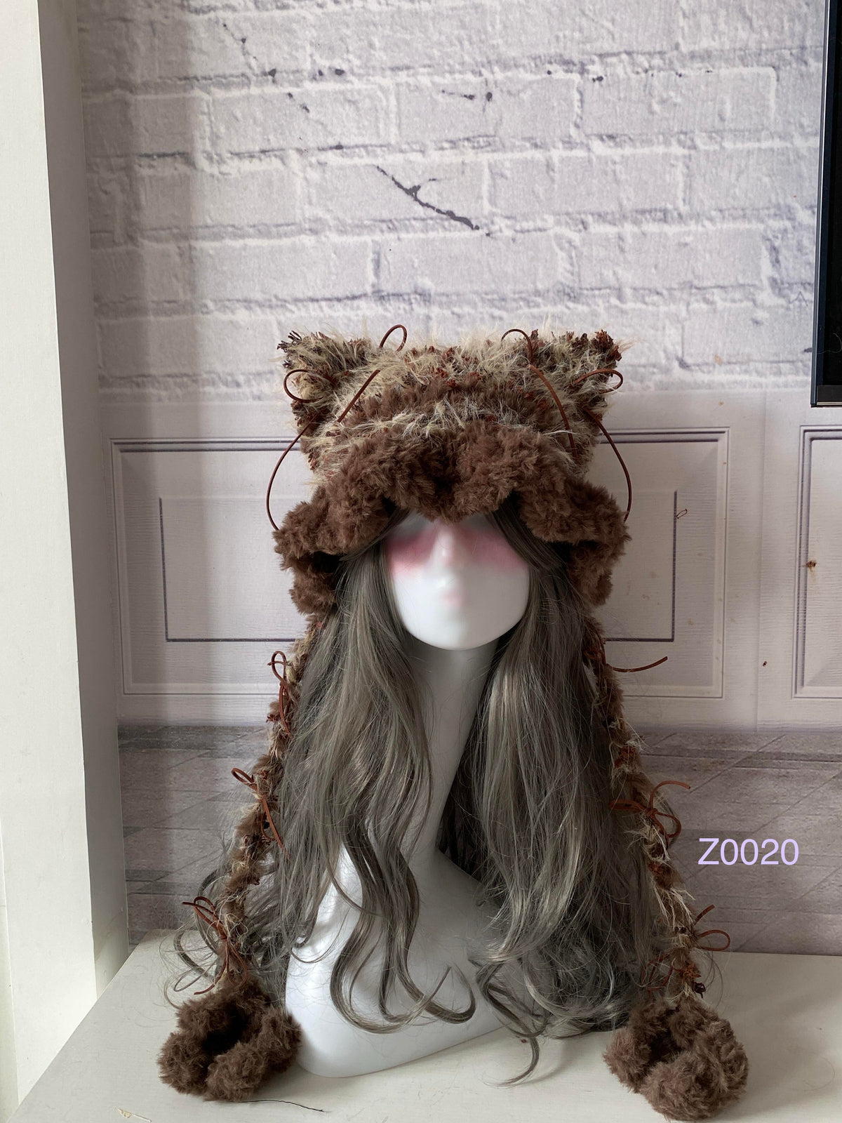 handmade crochet woodland cottagecore cat ear hat in brown and camel mixed fluffy texture with pointed ears and plush pompom ties. Mori girl style winter headwear for cosplay, festival and photoshoot styling