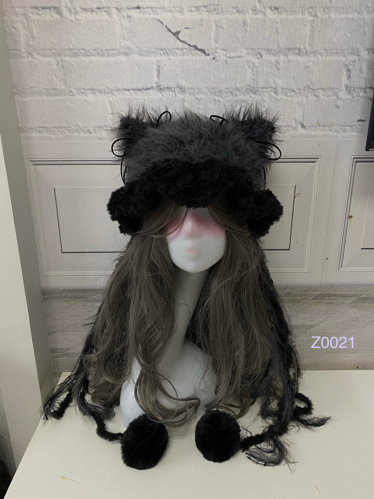 handmade crochet goth monochrome cat ear hat in black and gray fluffy texture with pointed ears and black pompom ties. Dark fairy cosplay headwear for rave party and winter photoshoots