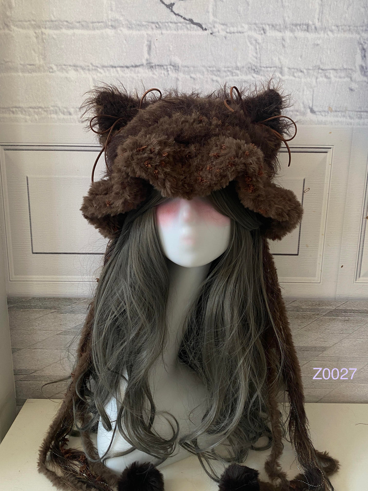 handmade crochet woodland goblincore cat ear hat in dark brown floral textured yarn with pointed ears and plush pompom ties. Cottagecore headwear for cosplay, festival and photoshoot styling