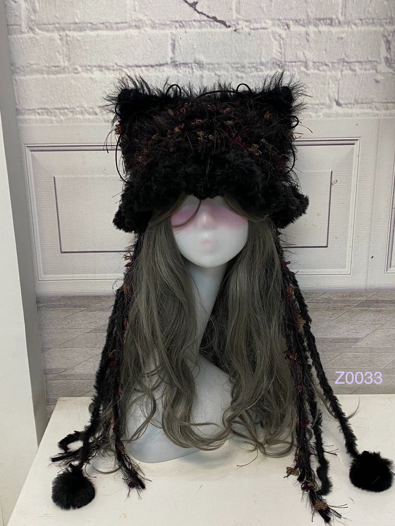 handmade crochet goth dark fairy cat ear hat in black and red mixed fluffy texture with pointed ears and black pompom ends. Whimsical cosplay headwear for rave party and winter photoshoots