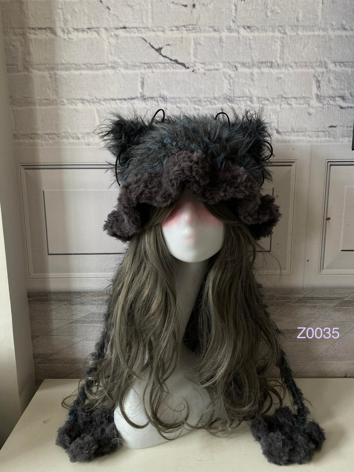 handmade crochet goth monochrome cat ear hat in gray and black mixed fluffy texture with pointed ears and plush pompom ties. Dark fairy cosplay headwear for rave party and winter photoshoots