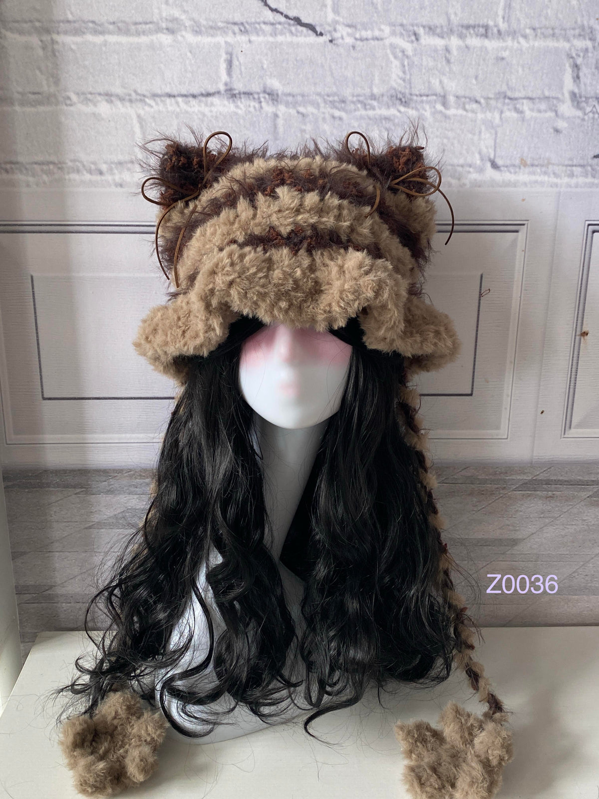 handmade crochet woodland cottagecore cat ear hat in brown striped fluffy texture with pointed ears and plush pompom ties. Mori girl style winter headwear for cosplay, festival and photoshoot styling