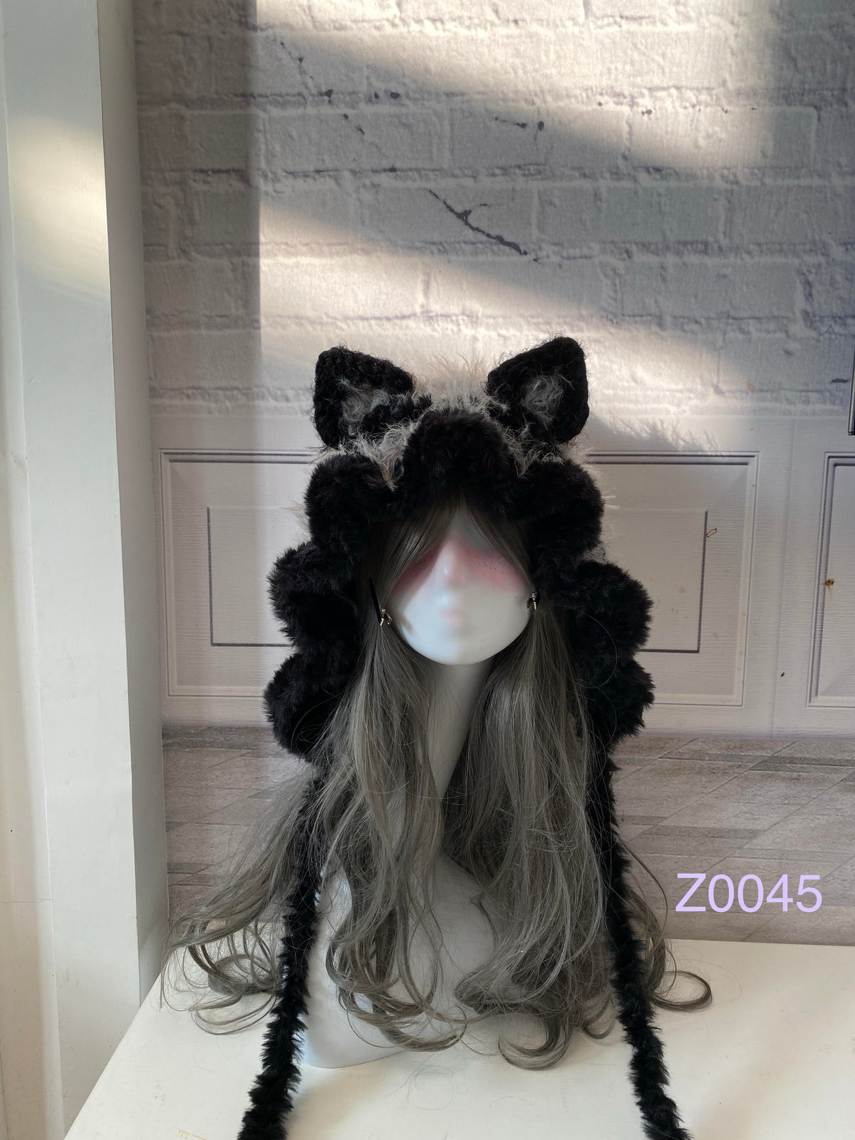 handmade crochet goth monochrome cat ear hood in black and gray fluffy contrast with pointed ears and long trailing ties. Dark fairy cosplay headwear for rave party and winter photoshoots