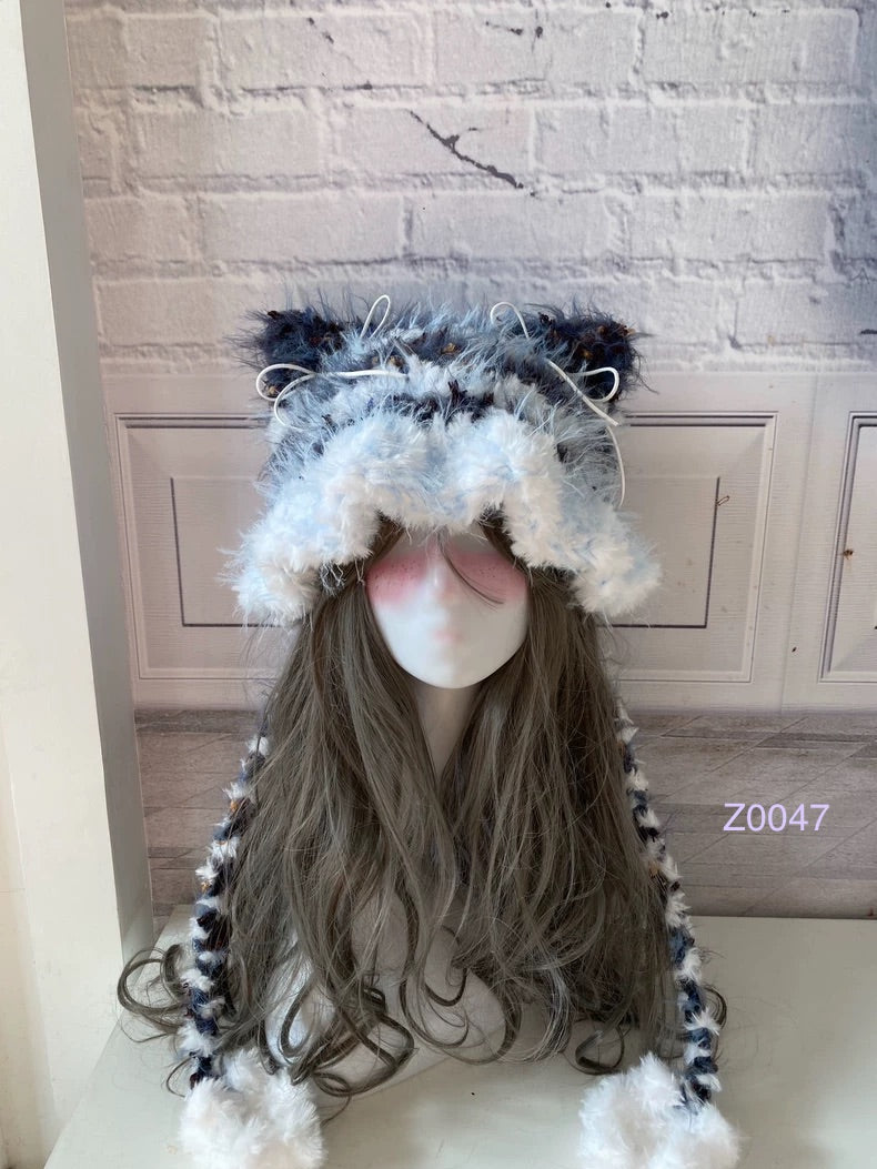 handmade crochet kawaii fairycore cat ear hat in blue and white fluffy contrast with pointed ears and white pompom ties. Cozy winter headwear for cosplay, photoshoot prop and gift idea
