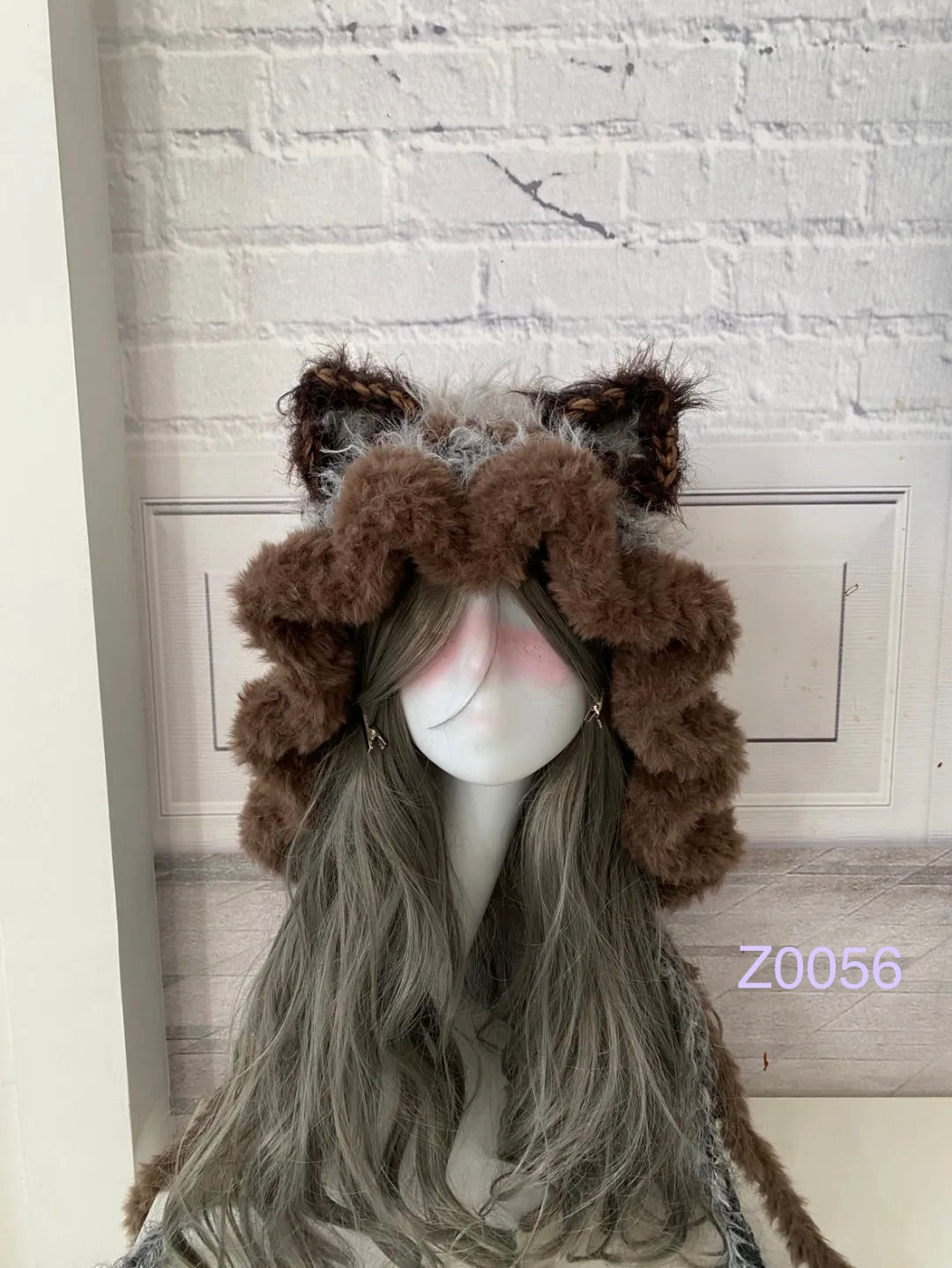 handmade crochet woodland cottagecore cat ear hood in dark brown and gray fluffy contrast with pointed ears and long trailing ties. Mori girl style winter headwear for cosplay, festival and photoshoot styling