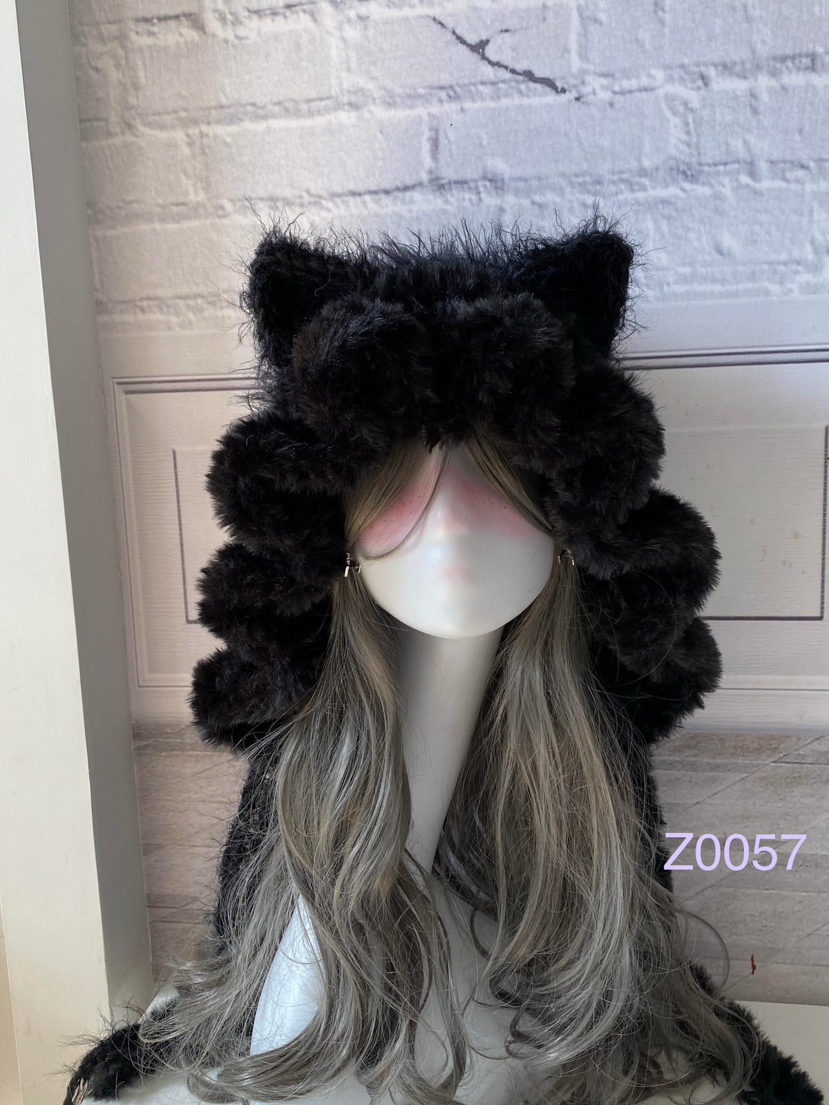 handmade crochet goth dark fairy cat ear hood in deep black fluffy texture with pointed ears and black satin ribbon ties. Whimsical cosplay headwear for rave party and winter photoshoots