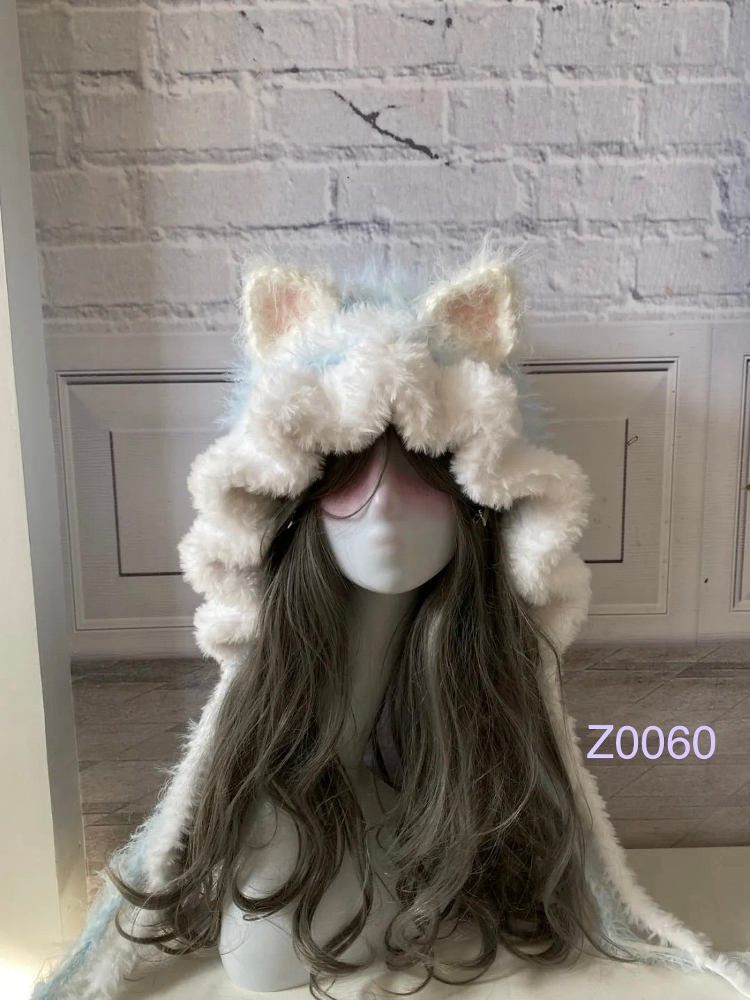 handmade crochet fairycore coquette cat ear hood in cream and pale blue fluffy contrast with pointed ears and long trailing ties. Sweet winter headwear for cosplay, photoshoot prop and gift idea