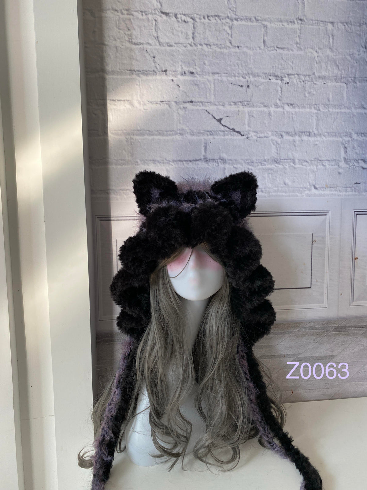 handmade crochet goth dark fairy cat ear hood in black and purple fluffy contrast with pointed ears and long trailing ties. Whimsical cosplay headwear for rave party and winter photoshoots