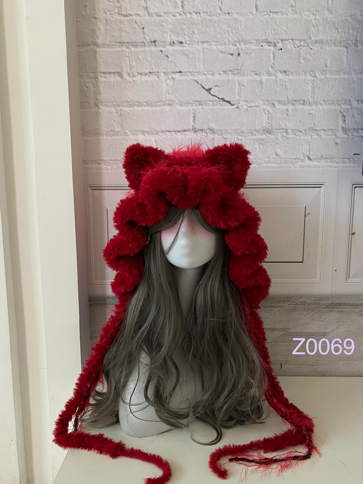 handmade crochet goth dark fairy cat ear hood in deep red fluffy texture with pointed ears and long trailing ties. Whimsical cosplay headwear for Halloween, rave party and winter photoshoots