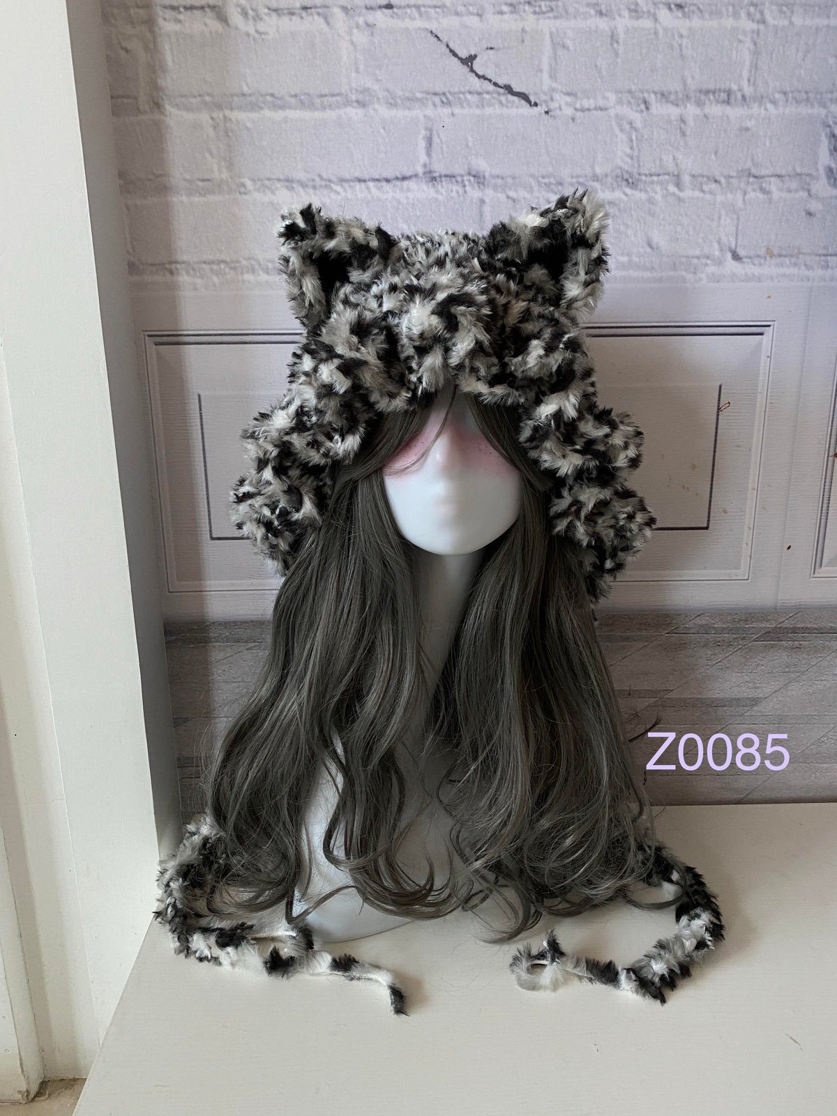 handmade crochet grunge monochrome cat ear hood in black and white leopard print fluffy texture with pointed ears and long trailing ties. Dark fairy cosplay headwear for rave party and winter photoshoots