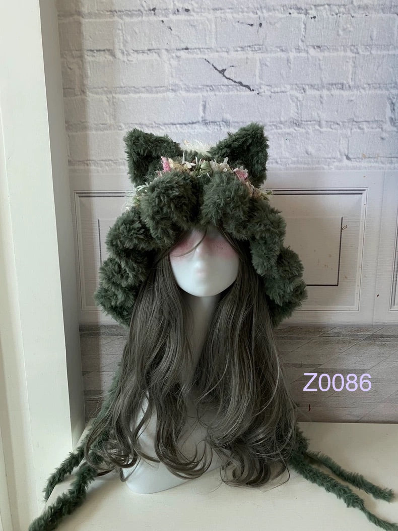 handmade crochet goblincore woodland cat ear hood in dark green floral fluffy texture with pointed ears and long trailing ties. Cottagecore headwear for cosplay, music festival and photoshoot styling