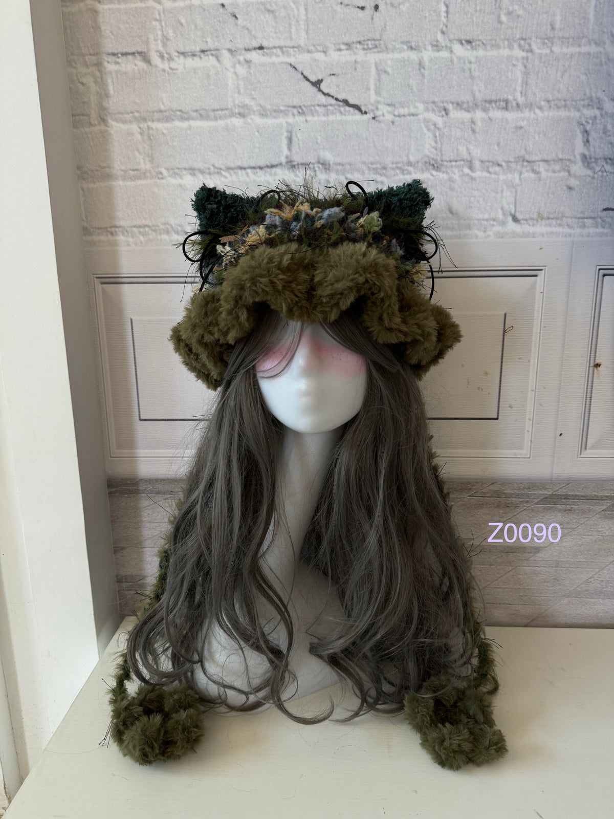 handmade crochet goblincore woodland cat ear hat in dark green mixed fluffy texture with pointed ears and long trailing ties. Cottagecore headwear for cosplay, festival and photoshoot styling