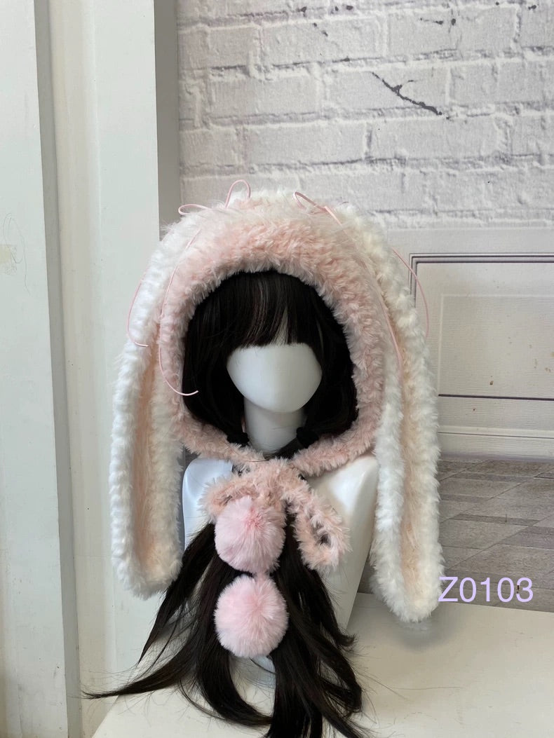 handmade crochet coquette kawaii bunny ear hood in fluffy pink and white texture, pink ribbon details and soft pompom ties. Sweet fairycore winter headwear for cosplay, photoshoot prop and gift idea