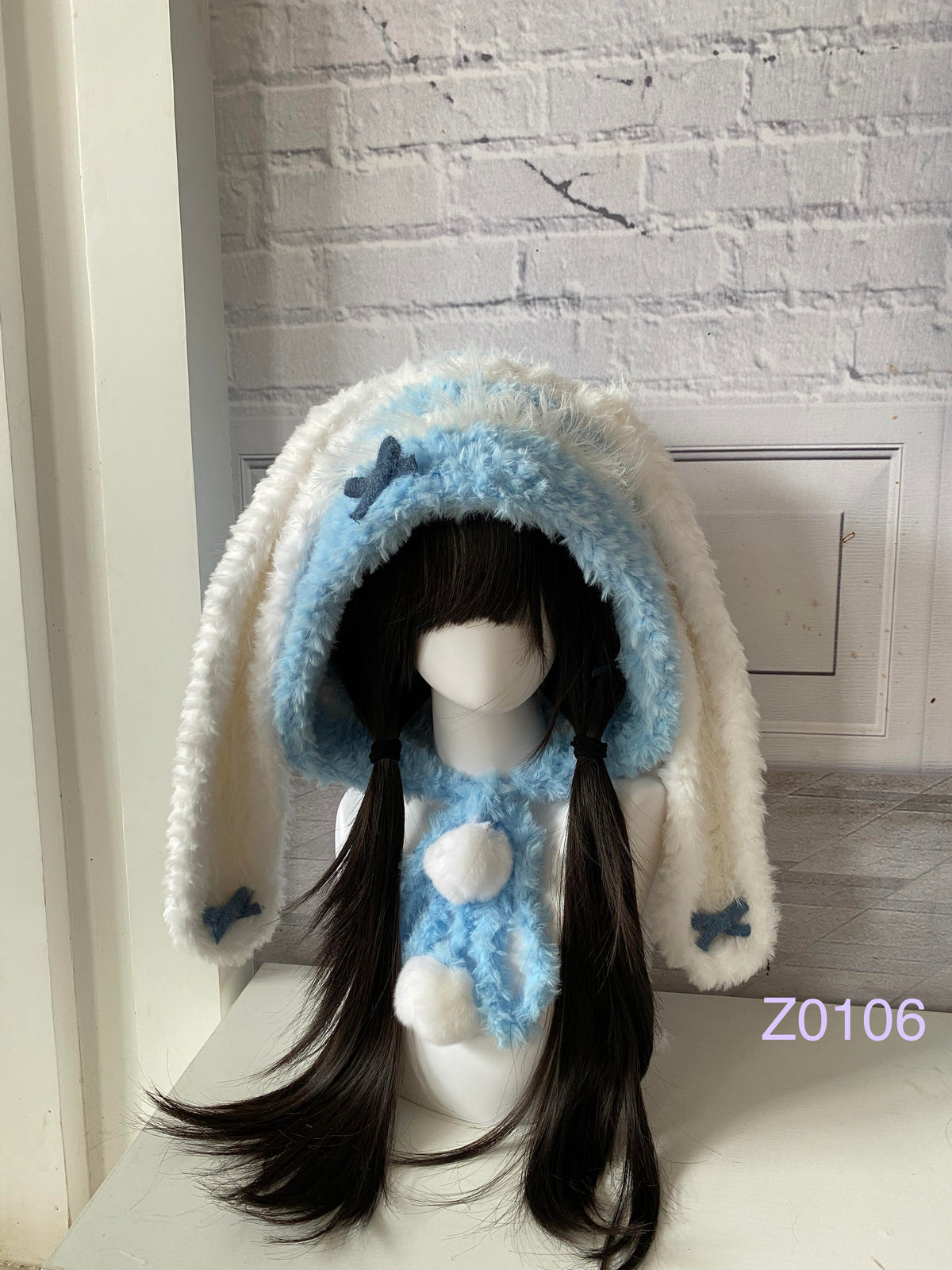 handmade crochet kawaii coquette bunny ear hood in blue and white fluffy contrast with long floppy ears, blue satin ribbons and plush pompom ties. Sweet fairycore winter headwear for cosplay, photoshoot prop and gift idea