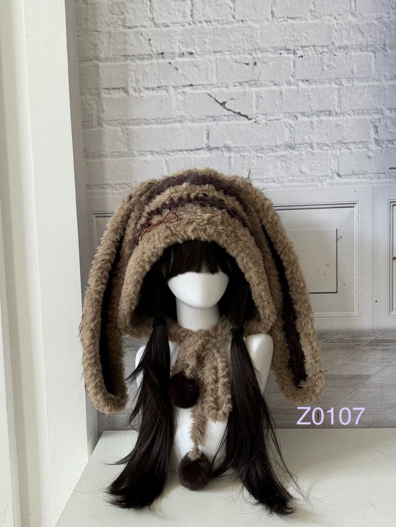 handmade crochet woodland cottagecore bunny ear hood in brown and cream fluffy texture with long floppy ears and pompom ties. Mori girl style winter headwear for cosplay, festival and photoshoot styling