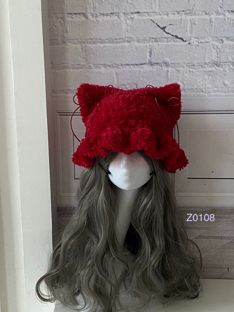 handmade crochet goth dark fairy cat ear hat in deep red fluffy texture with pointed ears and long trailing ties. Whimsical cosplay headwear for Halloween, rave party and winter photoshoots