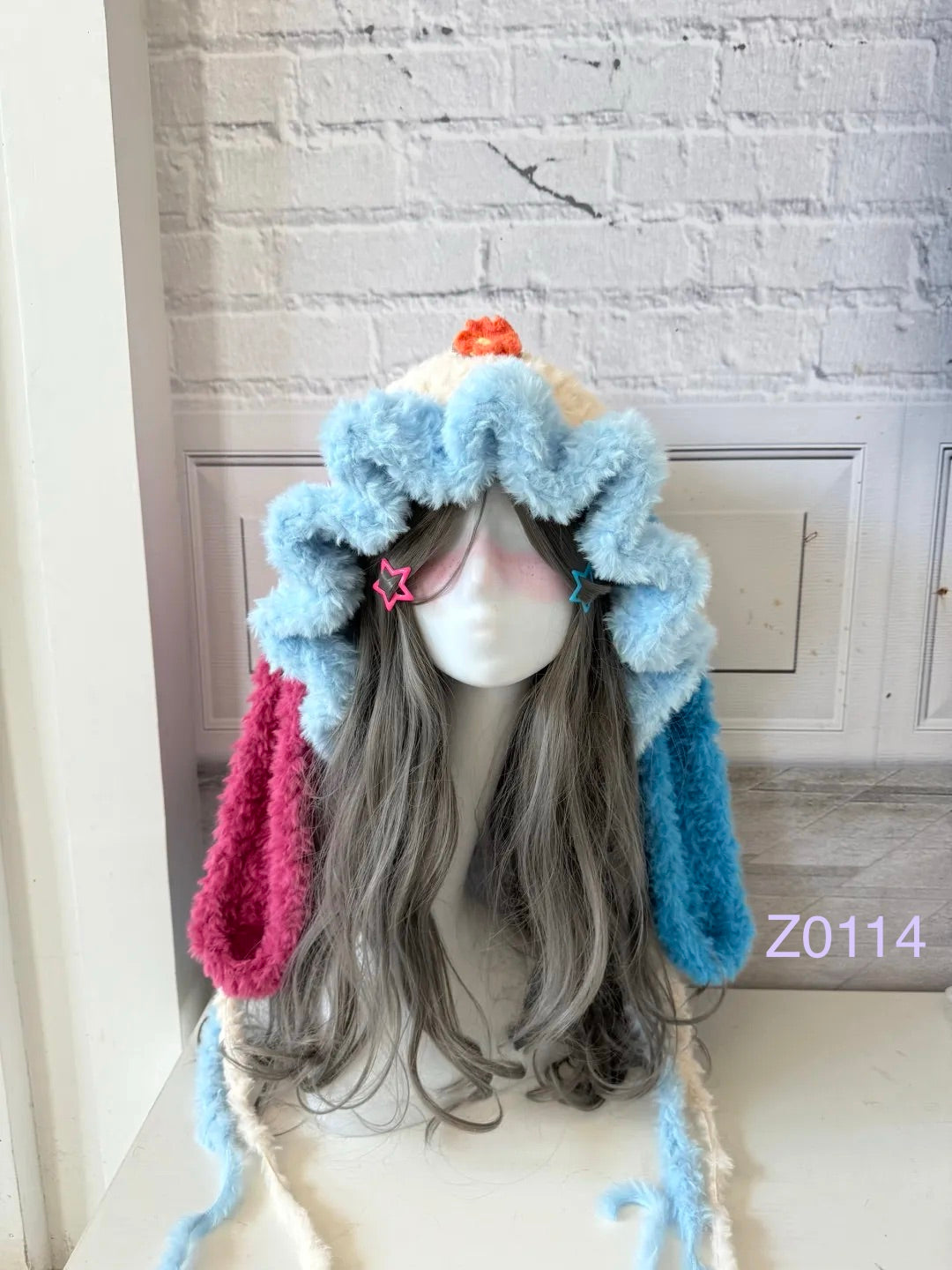 handmade crochet kawaii y2k fairy bunny ear hood in usahana inspired pink and blue fluffy contrast with flower accent, long floppy ears and soft pompom ties. Sanrio style cosplay headwear for rave party, photoshoot prop and festival styling
