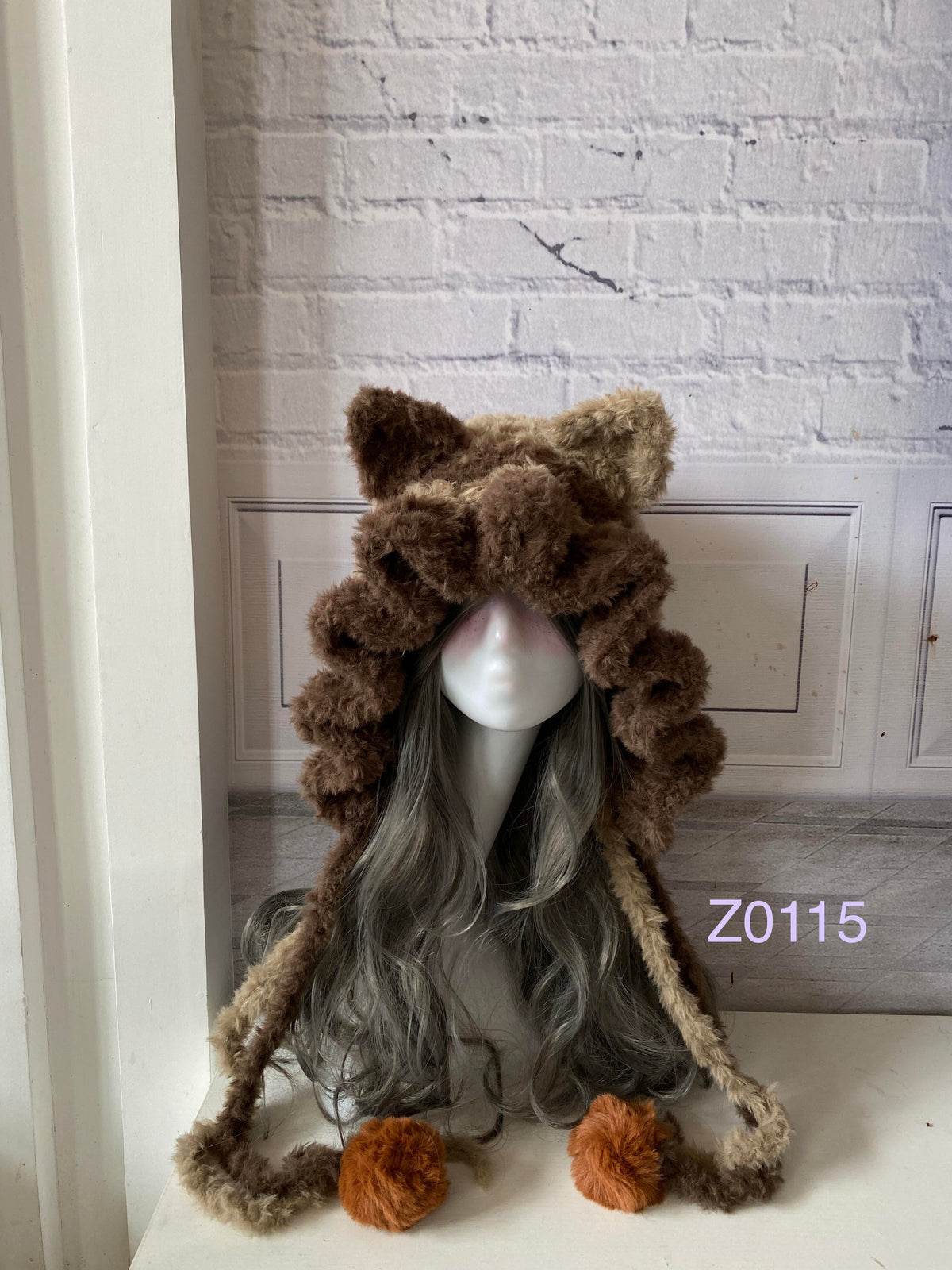 handmade crochet woodland cottagecore cat ear hood in brown and camel fluffy contrast with pointed ears and orange pompom ties. Mori girl style winter headwear for cosplay, festival and photoshoot styling