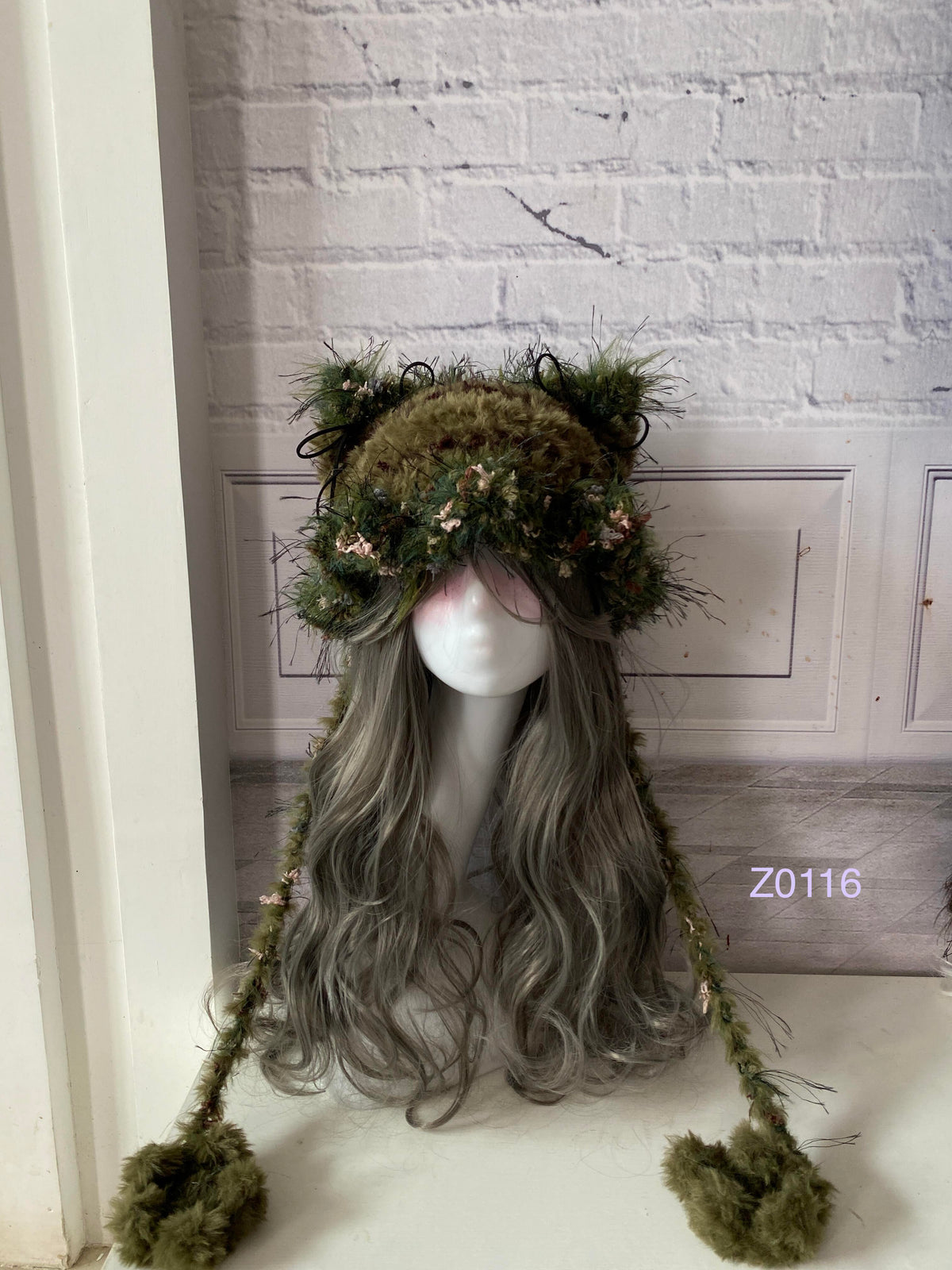 handmade crochet goth dark fairy cat ear hat in black and red mixed fluffy texture with pointed ears and plush pompom ends. Whimsical cosplay headwear for rave party and winter photoshoots