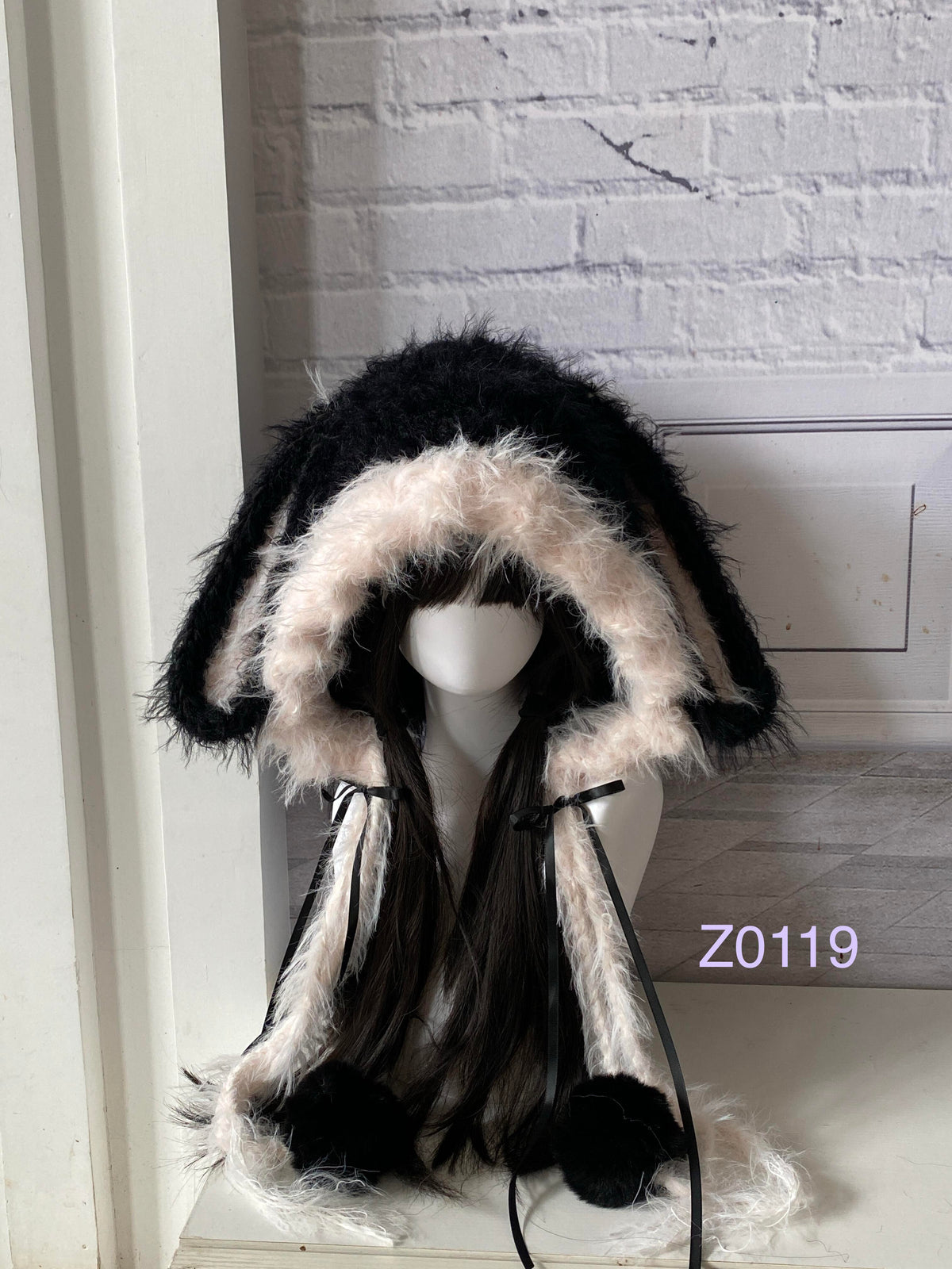 handmade crochet goth coquette bunny ear hood with striking black and pink fluffy contrast, black satin ribbons and fur pompom ties. Dark fairy headwear for cosplay, party and photoshoot styling