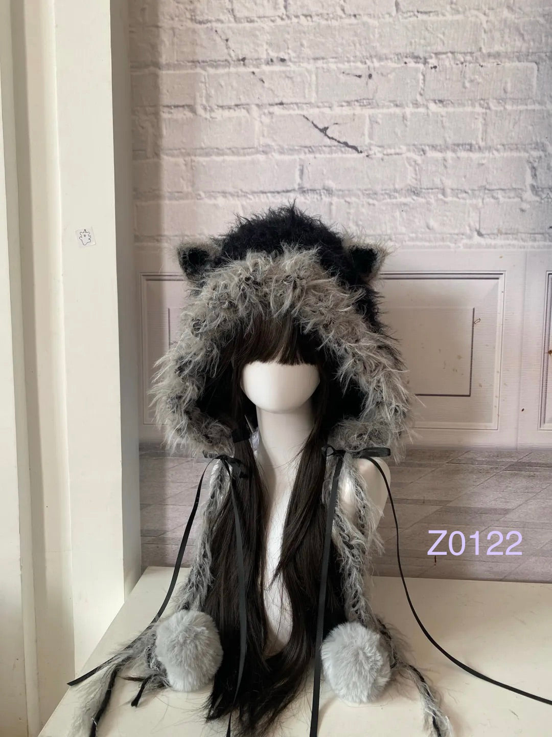 handmade crochet goth dark fairy cat ear hood with black and gray fluffy contrast, black satin ribbons and fur pompom ends. Whimsical cosplay headwear for rave party and winter photoshoots