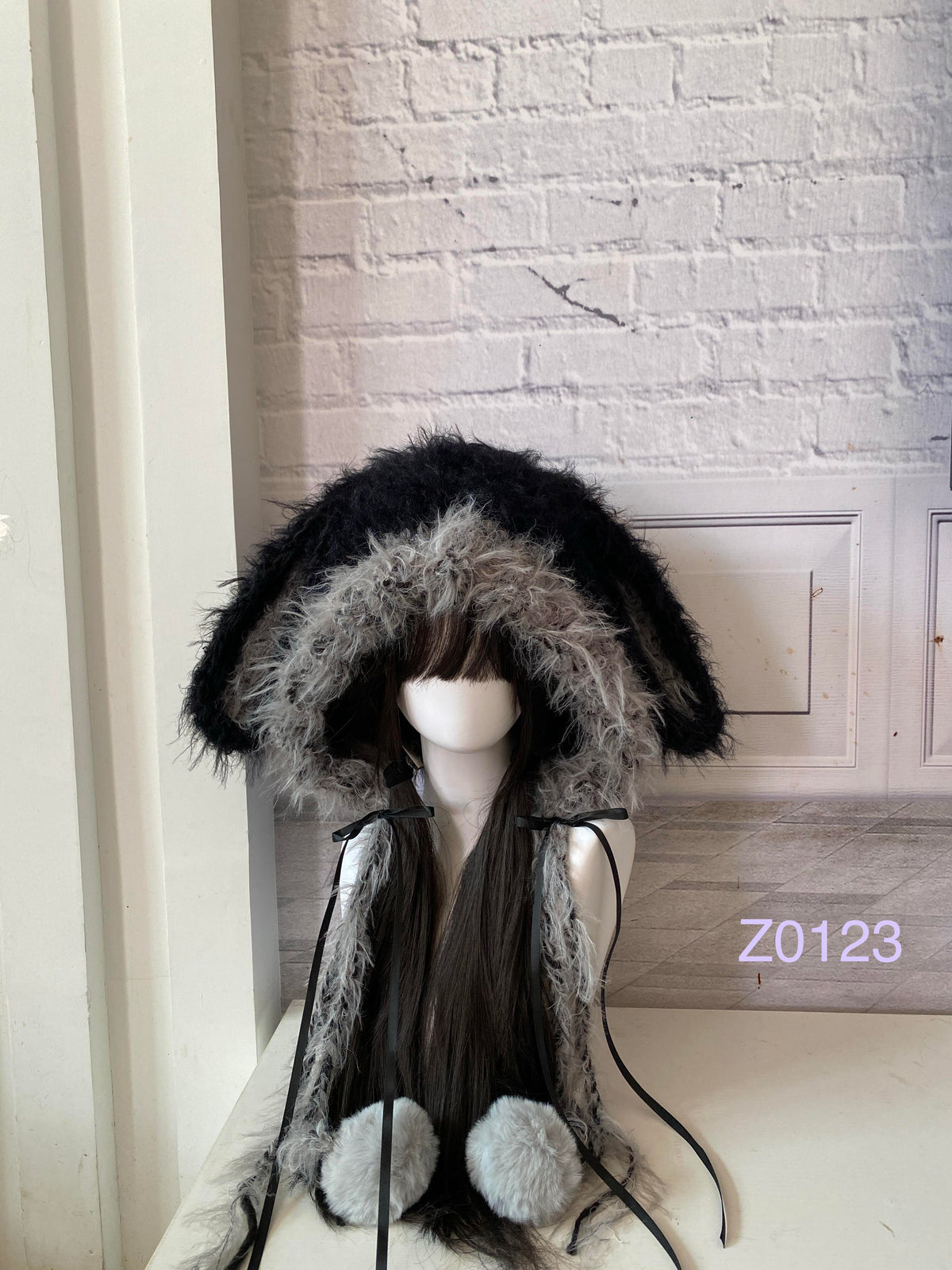handmade crochet goth dark fairy bunny ear hood with black and gray fluffy contrast, black satin ribbons and pale fur pompom ties. Whimsical cosplay headwear for rave party and winter photoshoots