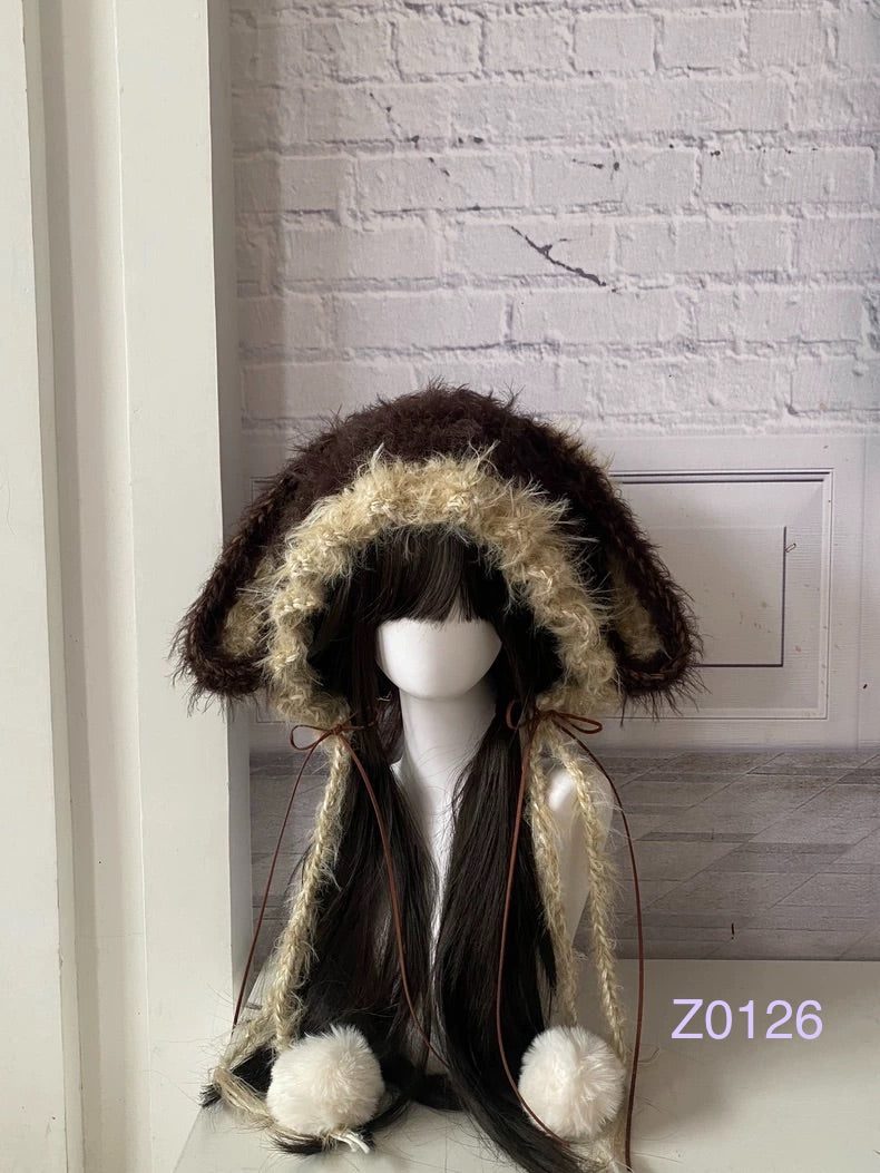 handmade crochet woodland cottagecore bunny ear hood in dark brown and cream fluffy contrast, brown satin ribbons and white pompom ties. Mori girl style headwear for cosplay, festival and photoshoot styling