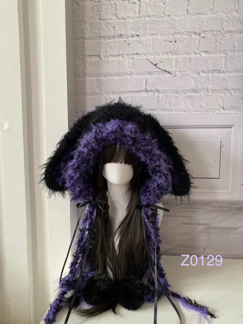 handmade crochet goth dark fairy bunny ear hood with bold black and purple fluffy contrast, black satin ribbons and fur pompom ends. Whimsical cosplay headwear for rave party and photoshoot styling