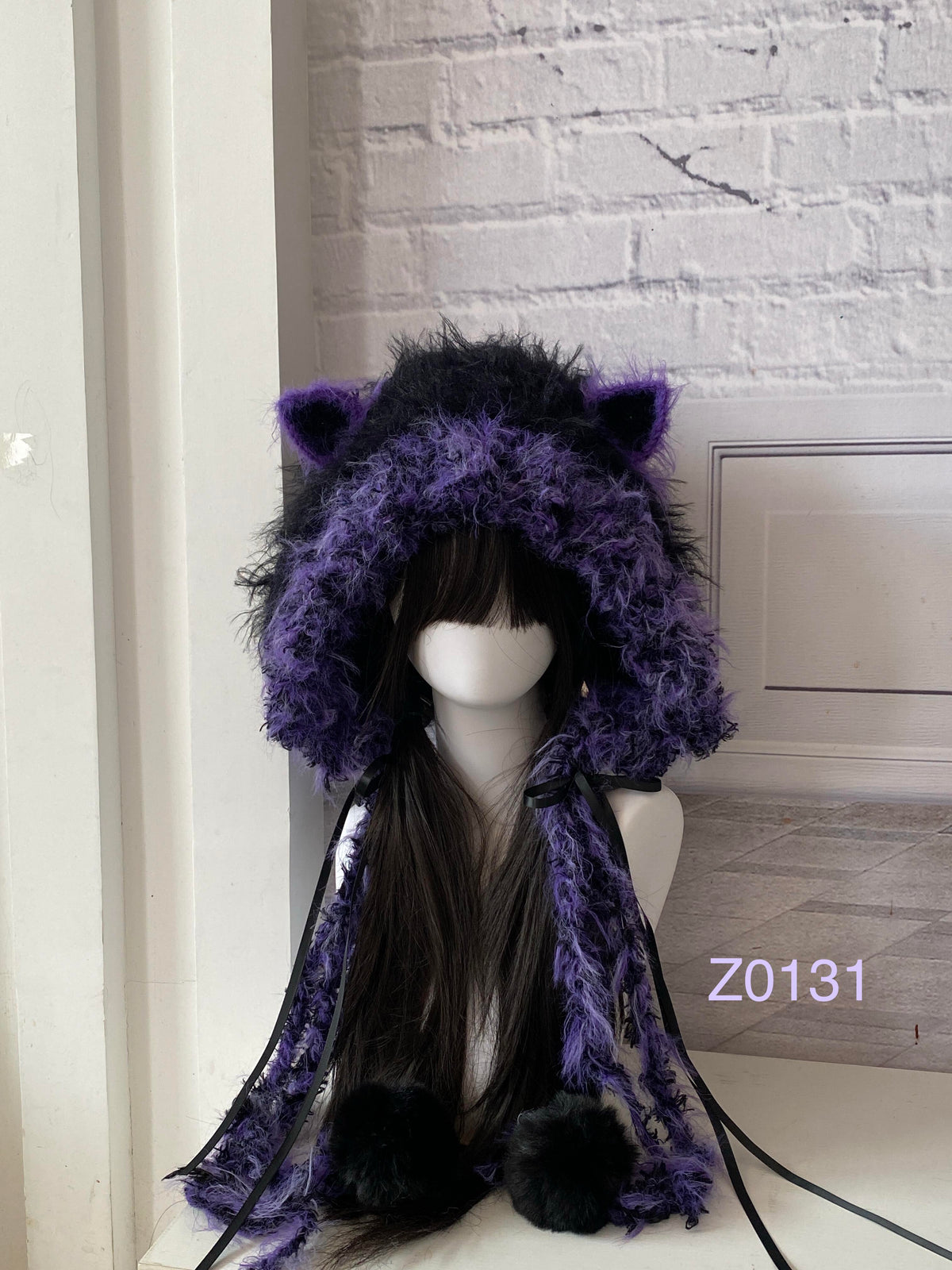 handmade crochet goth dark fairy cat ear hood with bold black and purple fluffy contrast, black satin ribbons and fur pompom ends. Whimsical cosplay headwear for rave party and photoshoot styling
