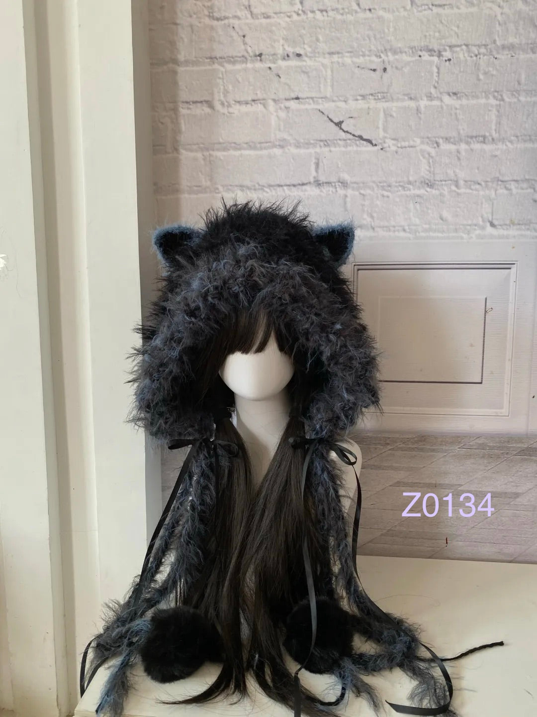 handmade crochet goth dark fairy cat ear hood with black and blue fluffy contrast, black satin ribbons and fur pompom ties. Cozy cosplay headwear for rave party and winter festival styling