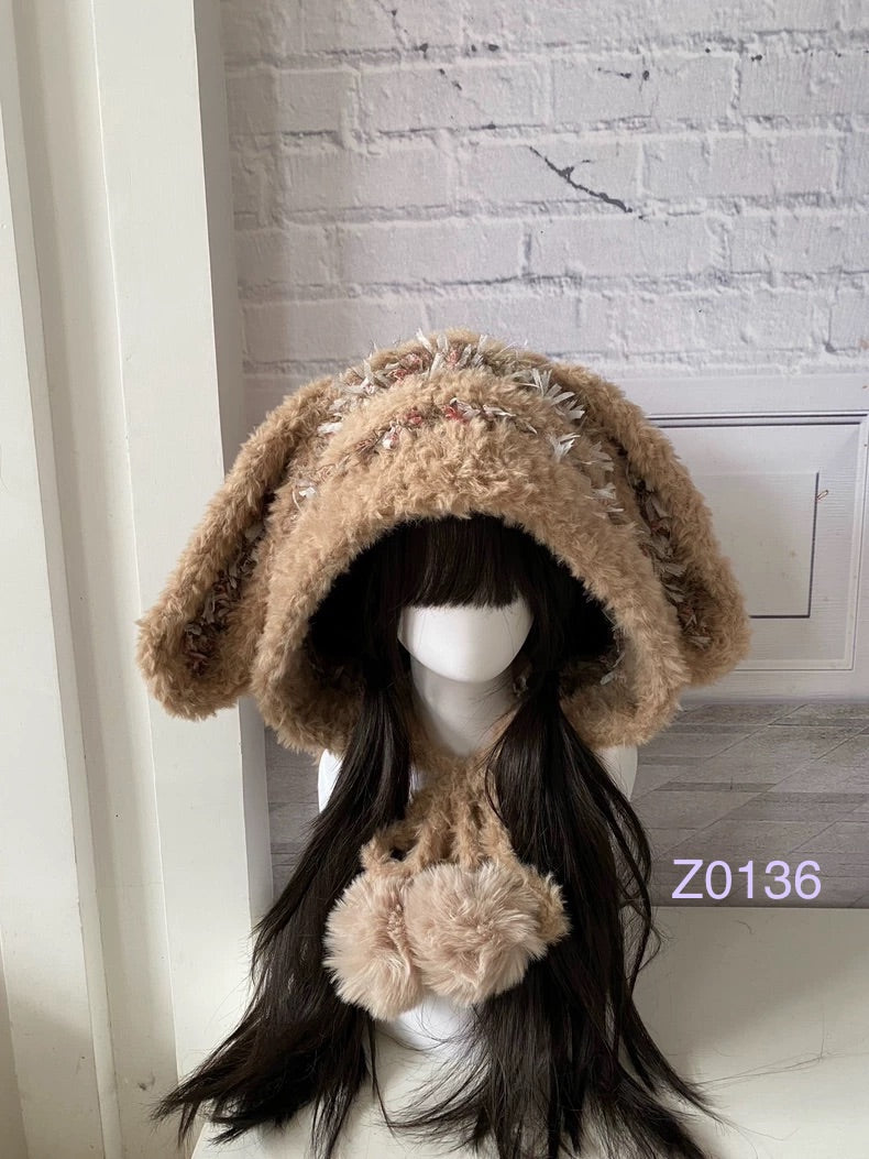 handmade crochet woodland cottagecore bunny ear hood in soft tan and floral textured yarn, long floppy ears and plush pompom ties. Mori girl style winter headwear for cosplay, festival and photoshoot styling