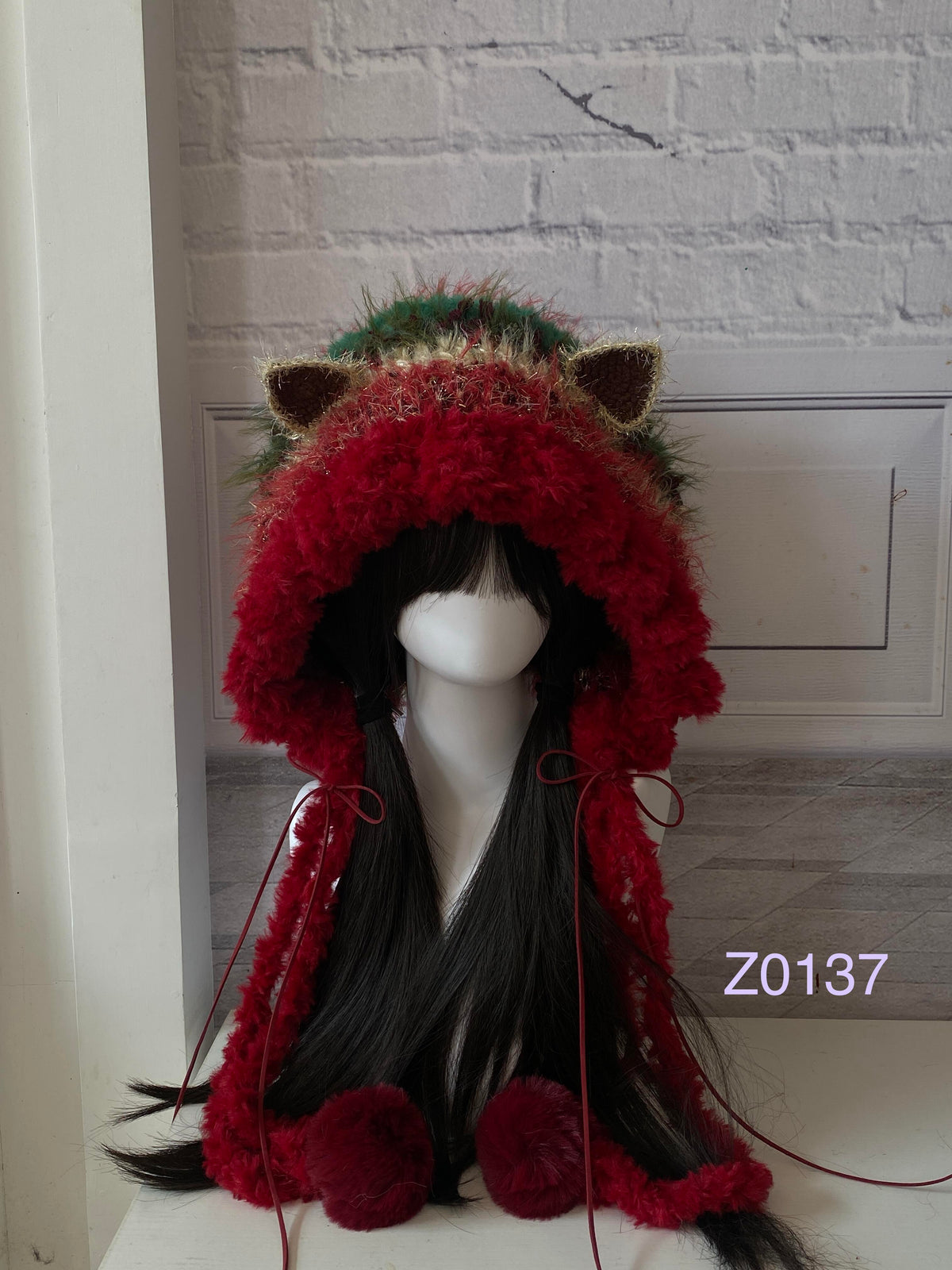 handmade crochet Christmas festive cat ear hood in bold red and green fluffy contrast, red satin ribbons and fur pompom ends. Holiday party headwear for cosplay, new year celebration and winter festival styling