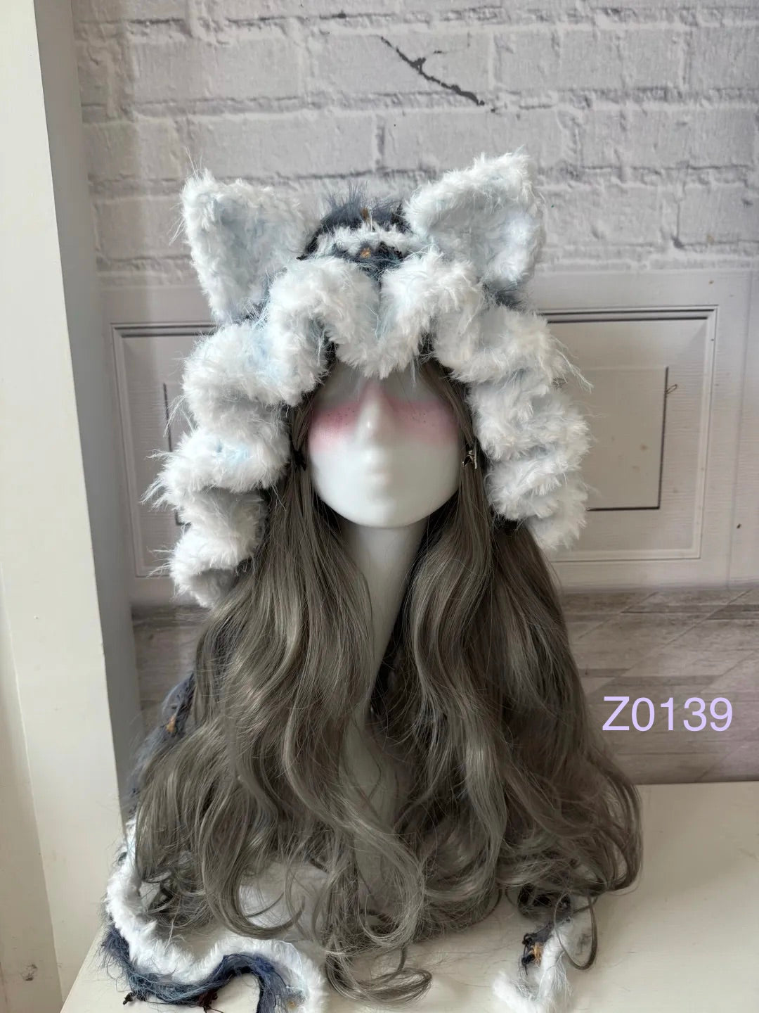 handmade crochet kawaii fairycore cat ear hood in blue and white fluffy contrast with pointed ears and soft trailing ties. Cozy winter headwear for cosplay, photoshoot prop and gift idea