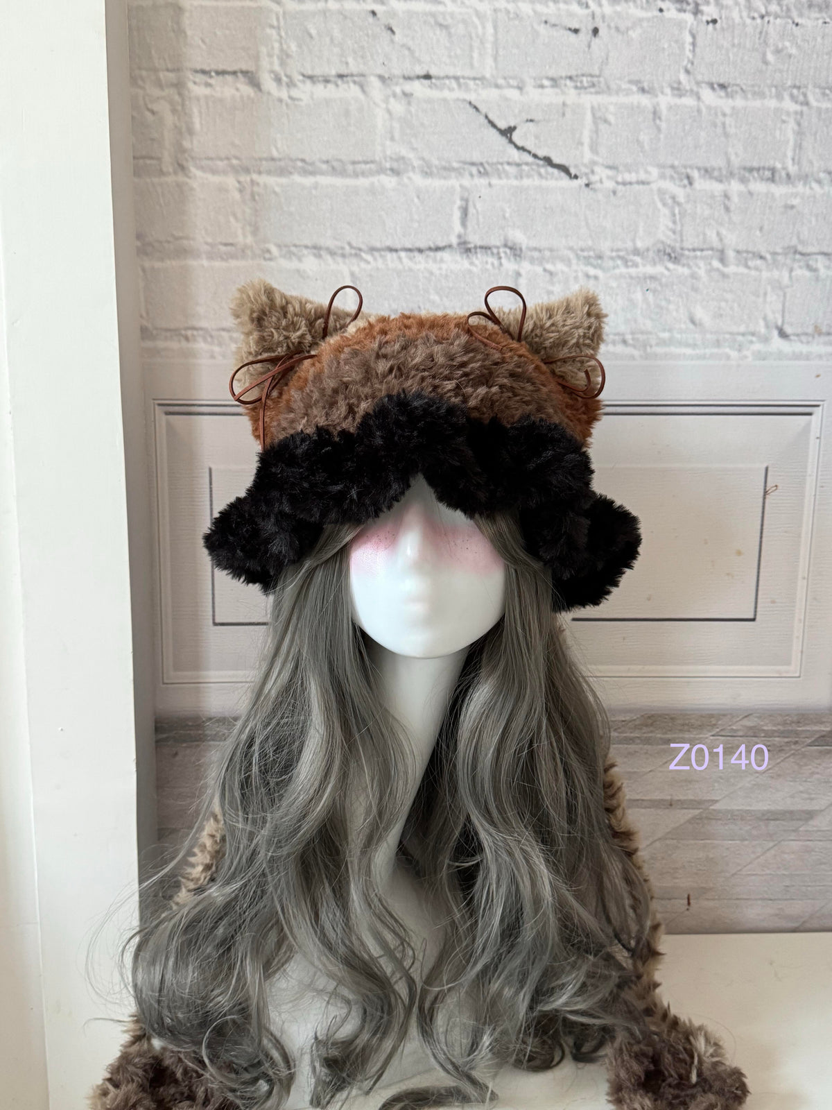 handmade crochet woodland monochrome cat ear hat in brown and black fluffy contrast with pointed ears and brown ribbon ties. Cottagecore headwear for cosplay, festival and photoshoot styling